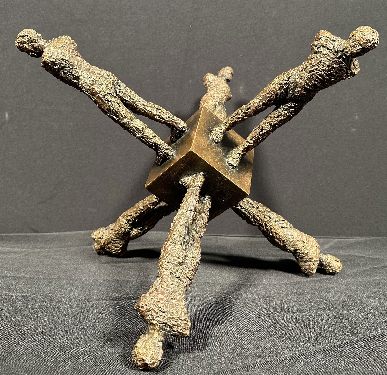 Six Figure Sculpture ala Ernest Trova Falling Man / Giacometti: Six Fiugre Sculpture around a central block. Reminiscent of Ernest Trova's Falling Man but with a bit of Giacometti texture/flavor to it. Composed of resin or some composite with a paint that makes yo