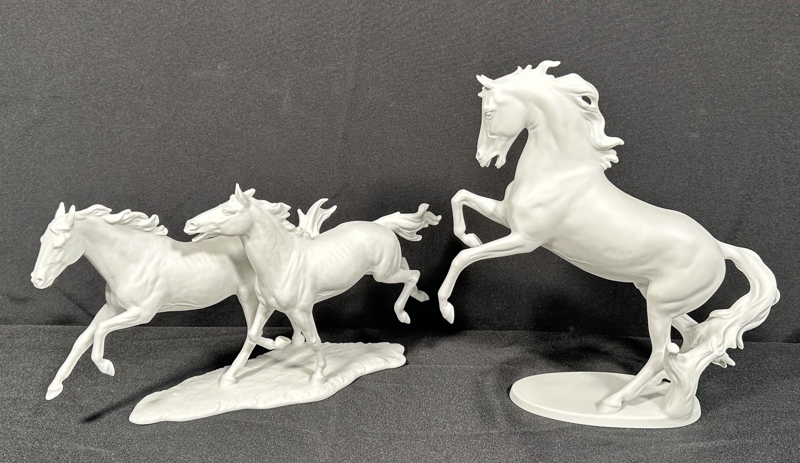 2 Kaiser Bisque Porcelain Horse Themed Figures: Two Kaiser horse bisque figurines including the proud rearing stallion. Please see photos for the condition to confirm, we found no issues at a cursory glance.This auction is using LiveShipping howeve