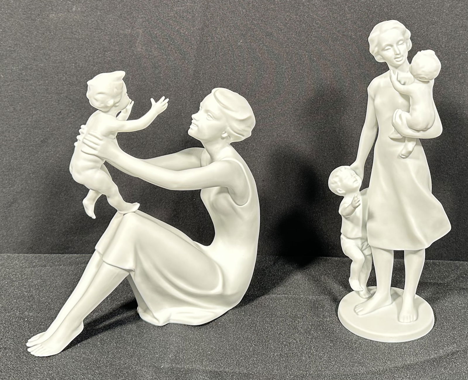 2 Kaiser Bisque Porcelain Motherhood Pieces: Two Kaiser motherhood related bisque figurines. Young, beautiful mothers playing and tending to their children. Please see photos for the condition to confirm, we found no issues at a cursory glance.T