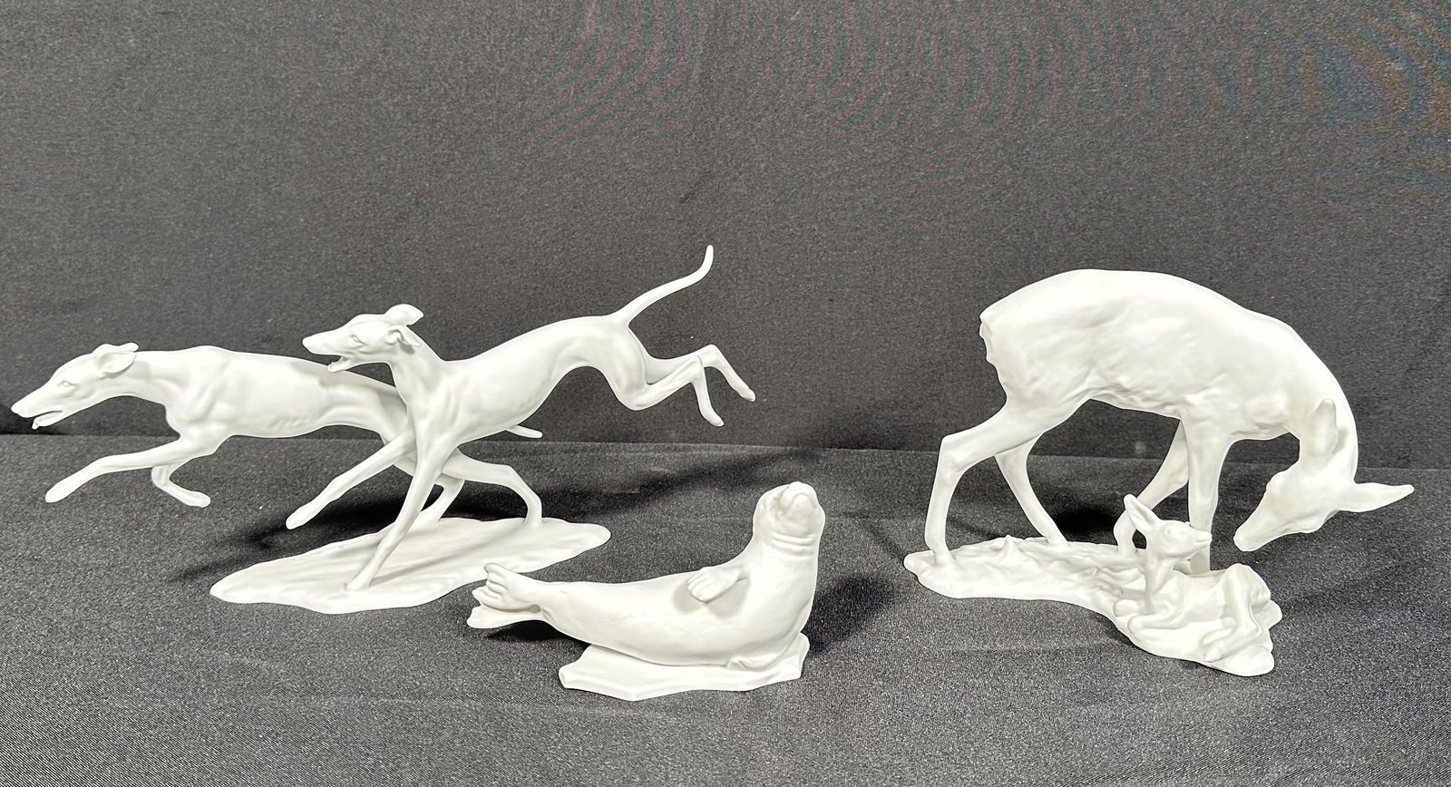 3 Kaiser Bisque Porcelain Animal Figures: Three Kaiser animal related bisque figurines including two dogs frolicing, a mother deer with her baby and a seal chilling on a floating piece of ice. Please see photos for the condition to confirm, w