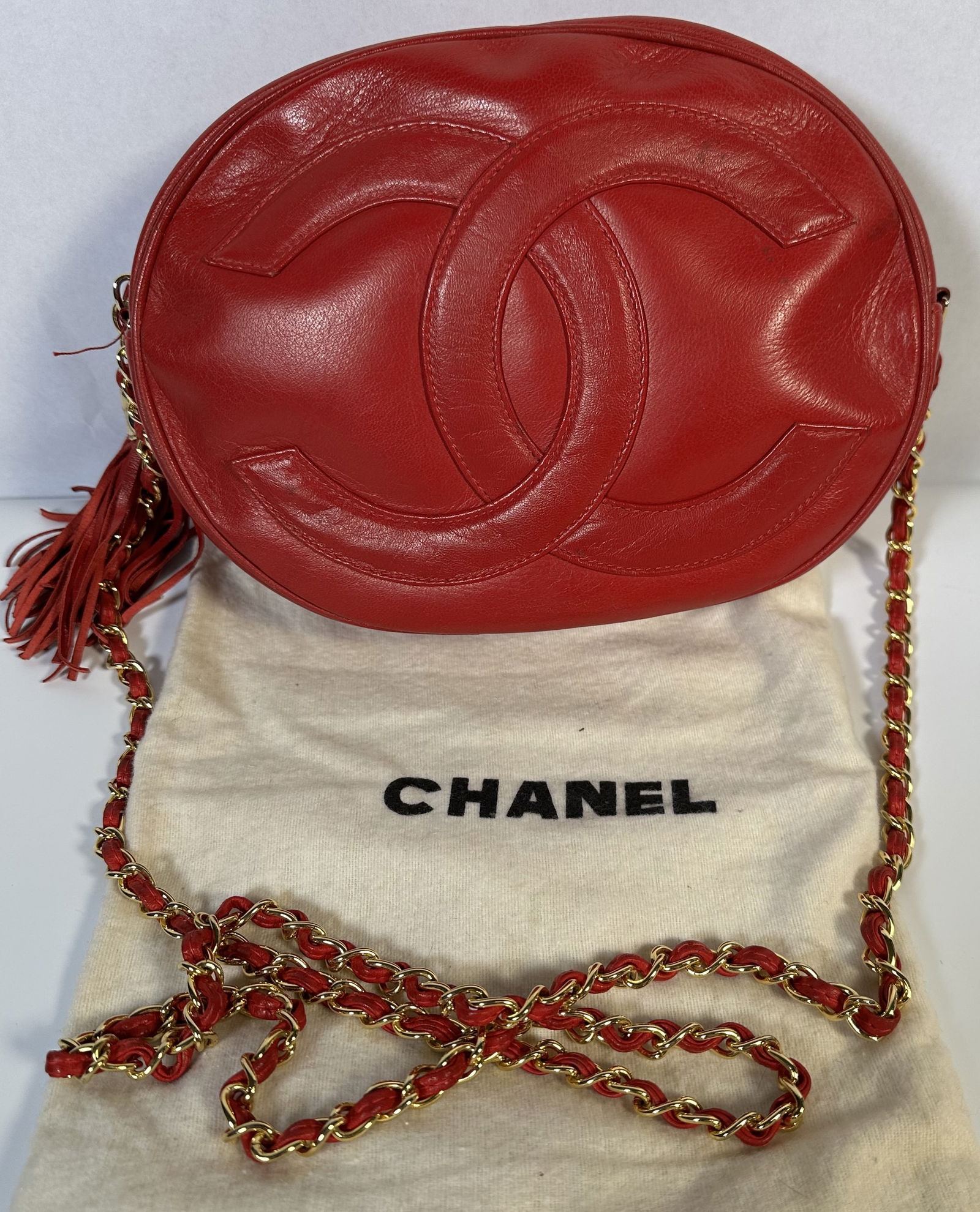 RR- Vintage Chanel CC Red Oval Mini Tassel Chain Bag: RR- Vintage Chanel CC Red Oval Mini Tassel Chain Bag >Great and different vintage Chanel bag is crafted into an oval shape and features the signature CC logo embossed at the front and a tassel to the