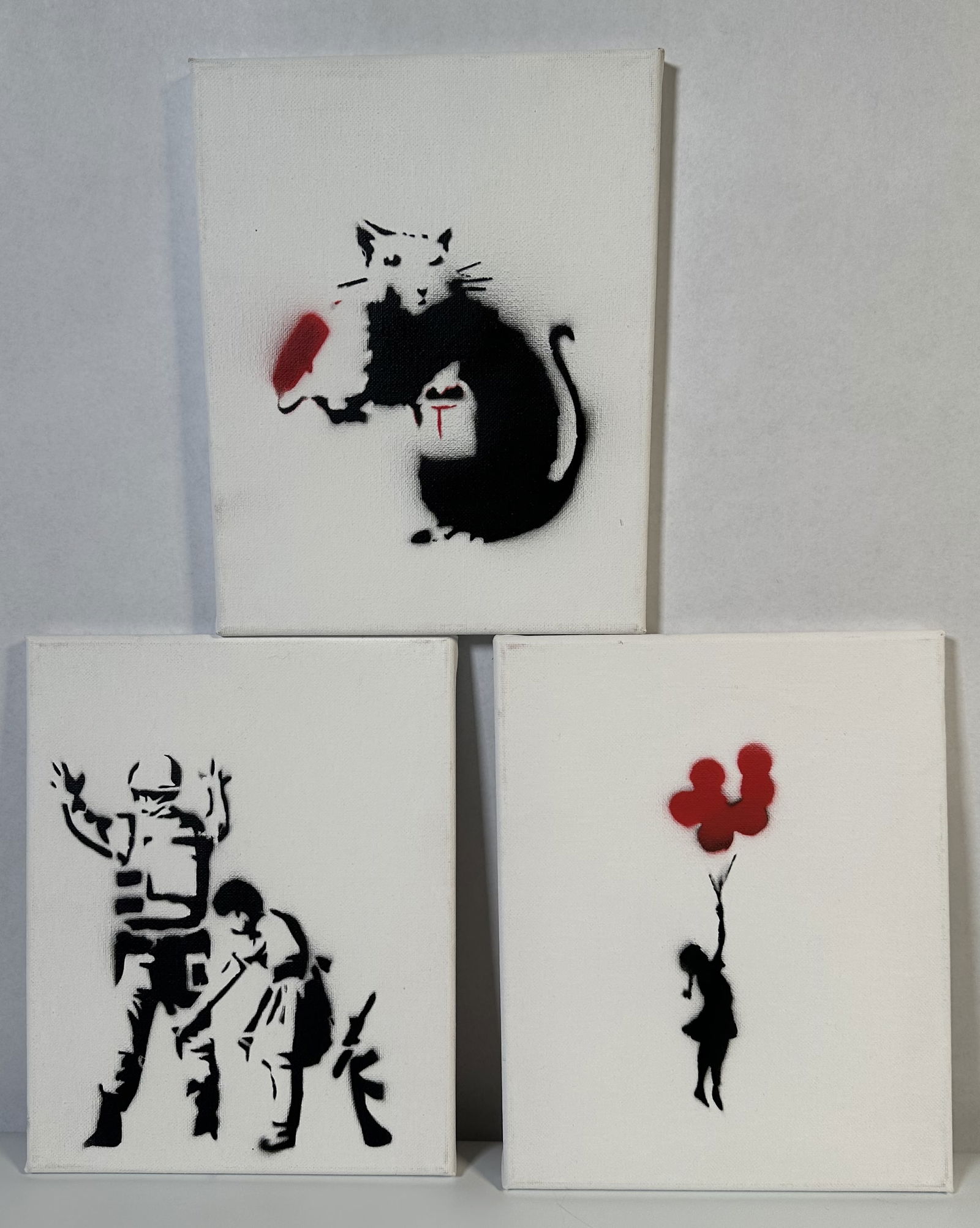 Three Stencil Paintings ala Banksy: Three Stencil Paintings ala Banksy Three stencil paintnigs on canvas all showing designs by Banksy. These were purchased within the past 10 years or so on the streets of NYC near Central Park. For th