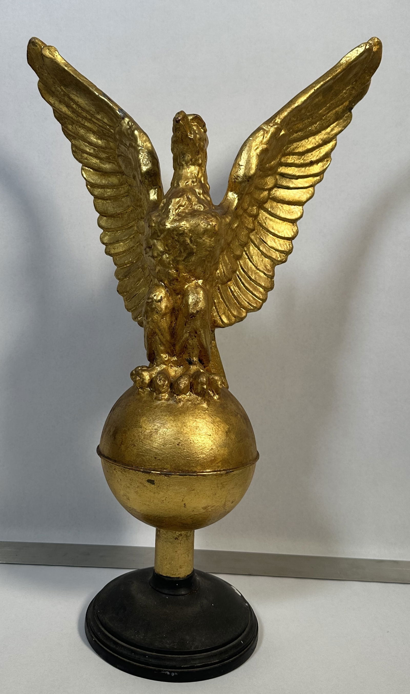 Gilt Metal Eagle on Stand 24 Inches Tall: Gilt Metal Eagle on Stand 24 Inches Tall Well done gold painted eagle on stand. The eagle itself is metal. Hard to tell which metal under all that paint. Great look.For this lot shipping can be done