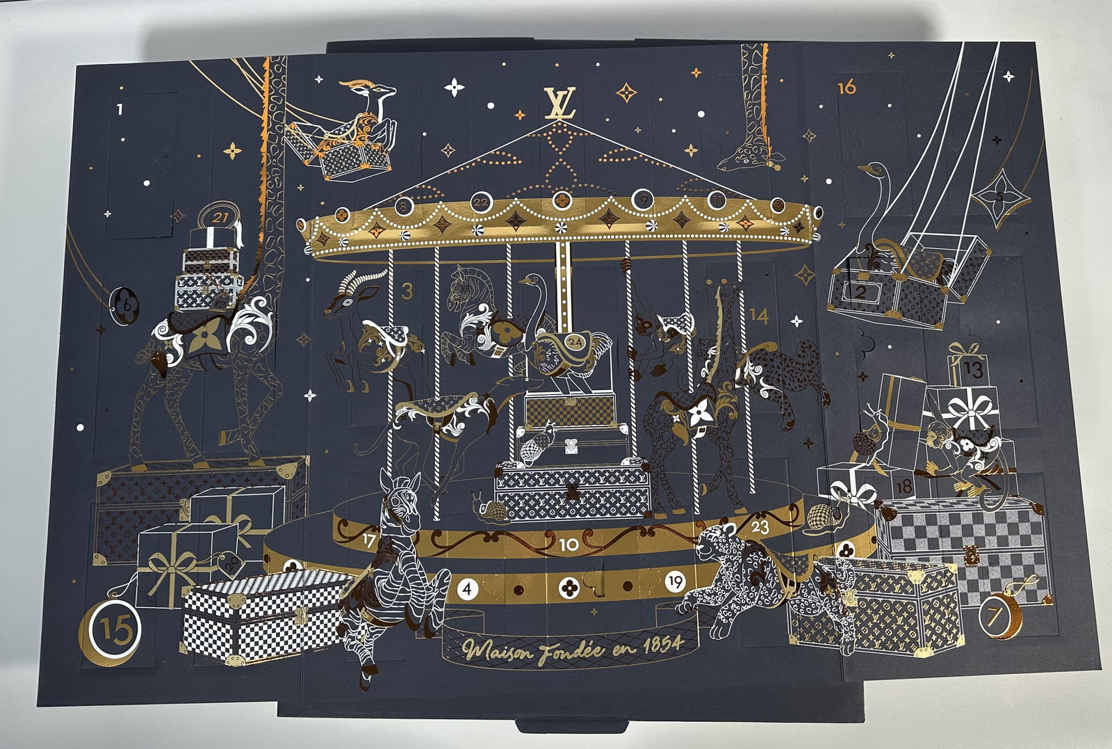 Louis Vuitton Advent Calendar: Louis Vuitton Advent Calendar Beautifully done Louis Vuitton holiday advent calendar with a carousel theme. 24 numbered doors revealing ornaments many of which can be folded out into more elaborage fo
