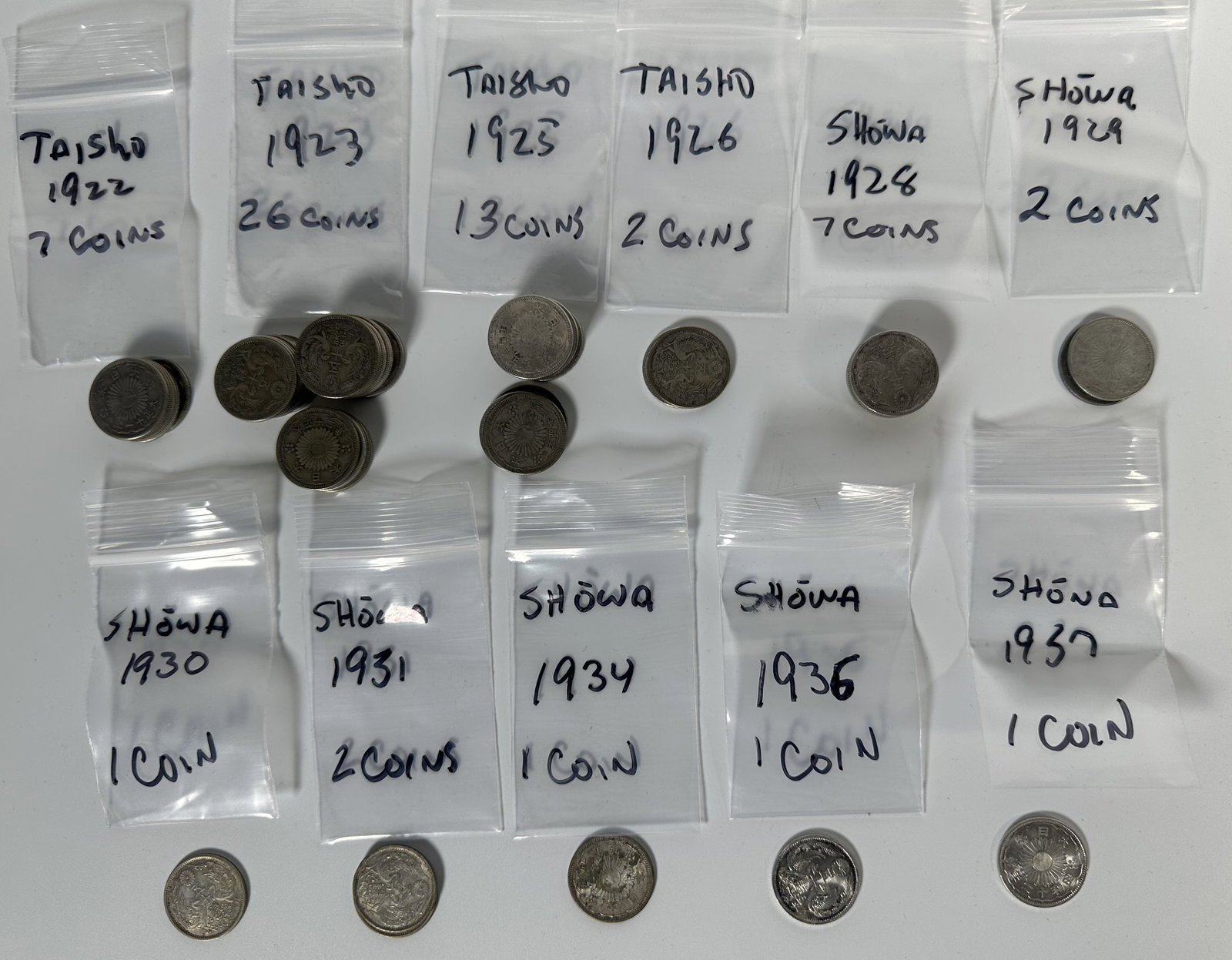 Japanese 50 Sen Taisho and Yoshito Period 63 Coins: Japanese 50 Sen Taisho and Yoshito Period 63 Coins This lot consists of 63 vintage 50 sen Japanese silver coins from the Taisho and Yoshito periods. Each coins weighs about 4.95 grams and consists of 