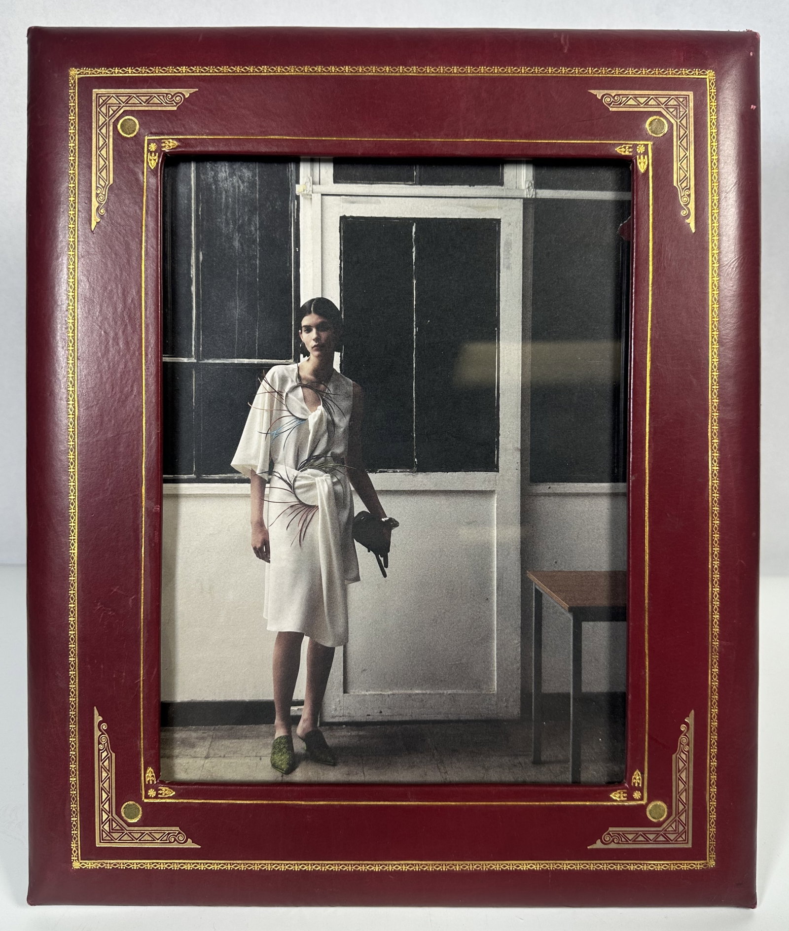 RR Vintage Burgundy Leather and Gold Detail Frame: Vintage Burgundy Leather and Gold Detail Frame This is a vintage-style burgundy leather photo frame featuring ornate gold embossed borders measuring about 14 inches by 12 inches overall. For this lot