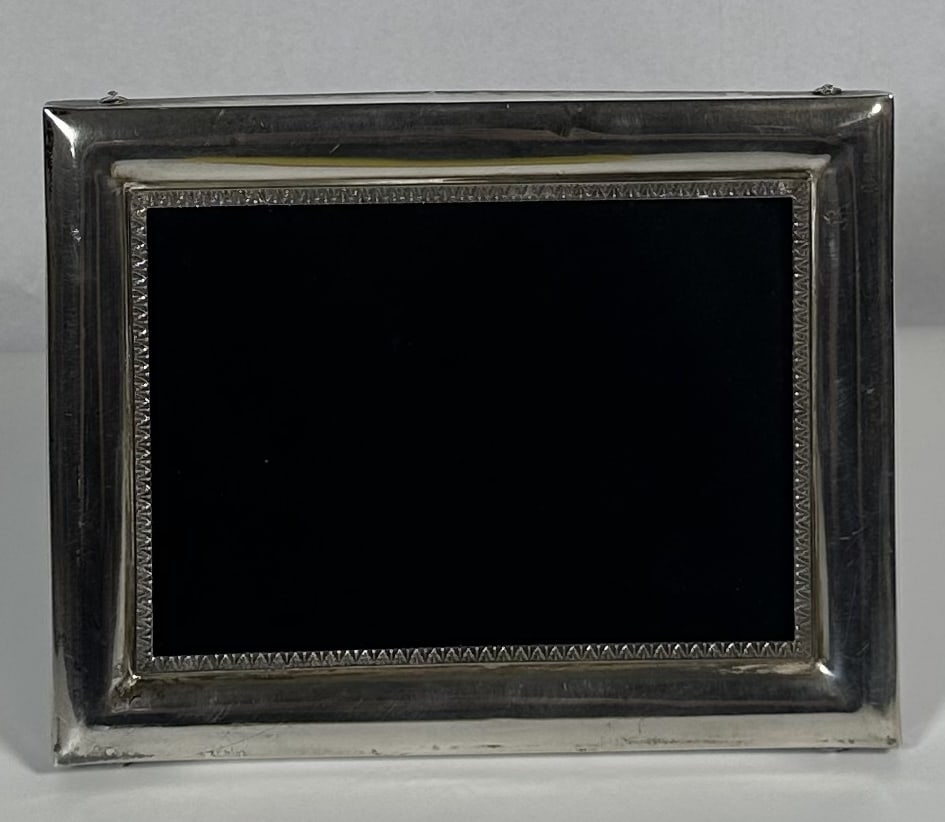 RR Sterling Silver and Wood LaLounis Picture Frame: Sterling Silver and Wood LaLounis Picture Frame This object is a vintage sterling silver picture frame by the renowned Greek jeweler Ilias Lalaounis. Known globally for his hand-finished gold jewelry