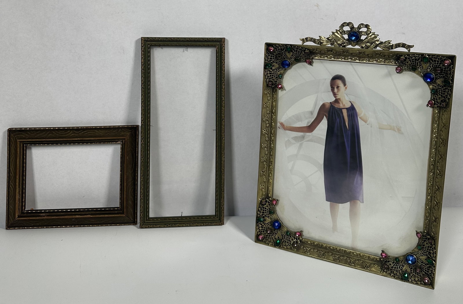 RR Three Vintage Decorative Frames: Three Vintage Decorative Frames Three decorative vintage table top frames with the stand-out piece featuring applied faux gemstones in an over-the-top Art Nouveau design. Please note the photo with
