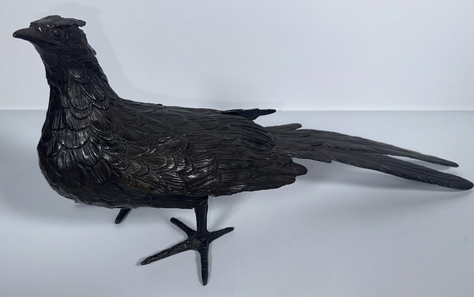 Vintage Bronze Finish Pheasant Figure: Vintage Bronze Finish Pheasant Figure This dark bronze-finish metal pheasant figurine features intricately textured feather detailing and a long, sweeping tail. For this lot shipping can be done one o