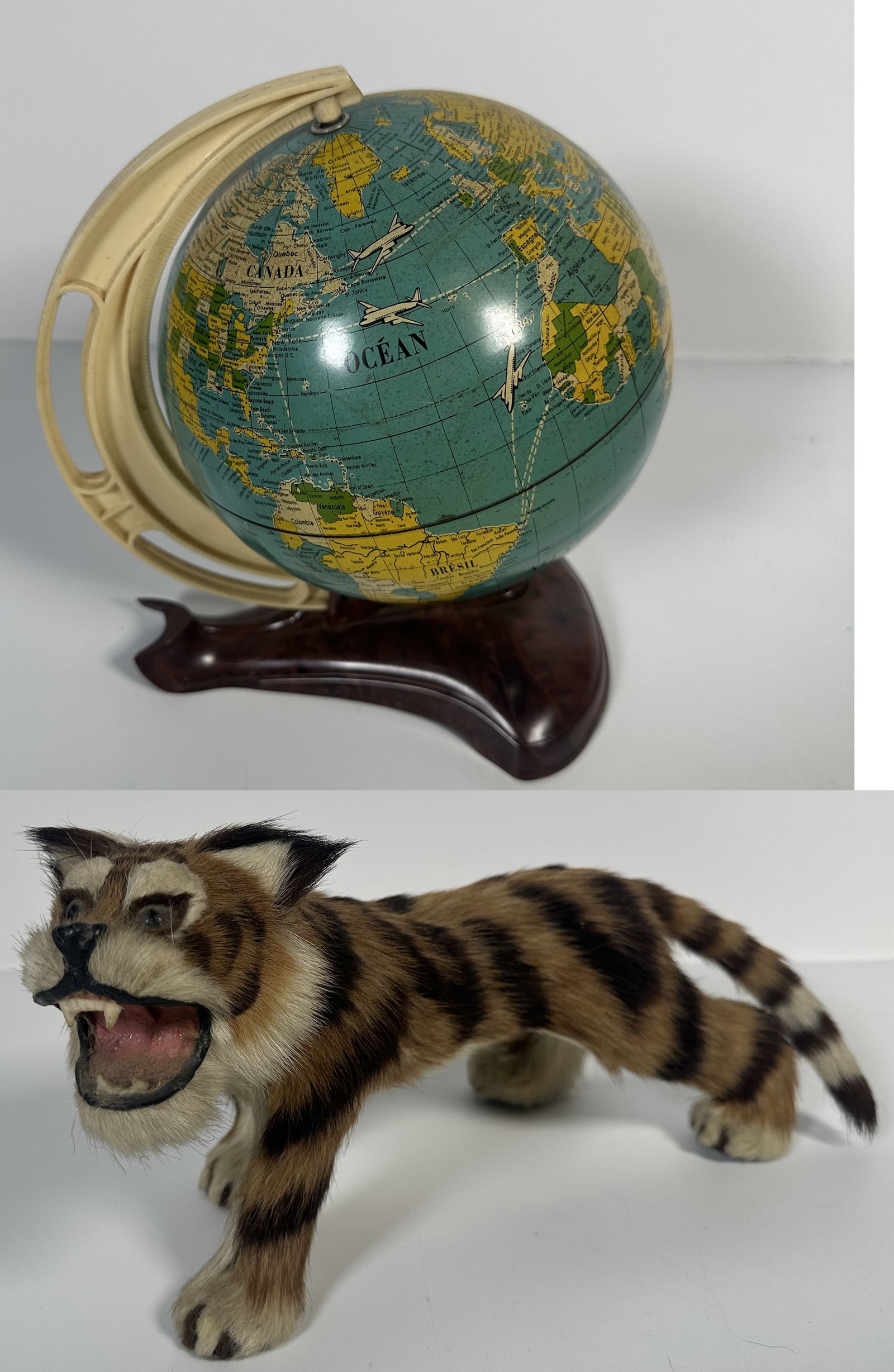 Vintage Globe and Tiger Toy: Vintage Globe and Tiger Toy This lot contains a small vintage globe that interestingly shows old flight routes. Made in West Germany. Also included is this toy tiger with fur and an Asian style. Both