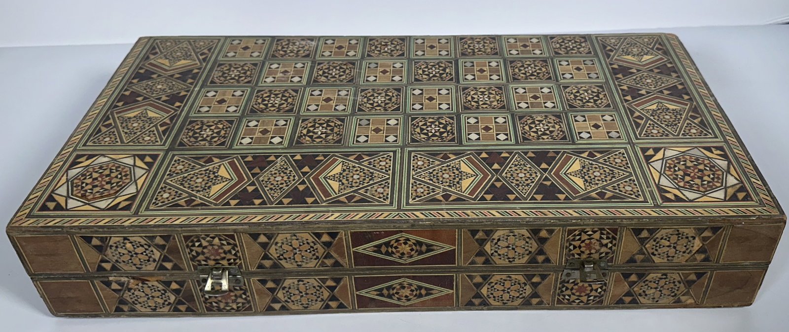 Damascus Mosaic Large Backgammon and Chess Inlaid Box: Damascus Mosaic Large Backgammon and Chess Inlaid Box This is a large traditional Damascus mosaic wood chess and backgammon board hand-inlaid with geometric marquetry patterns and mother-of-pearl acce