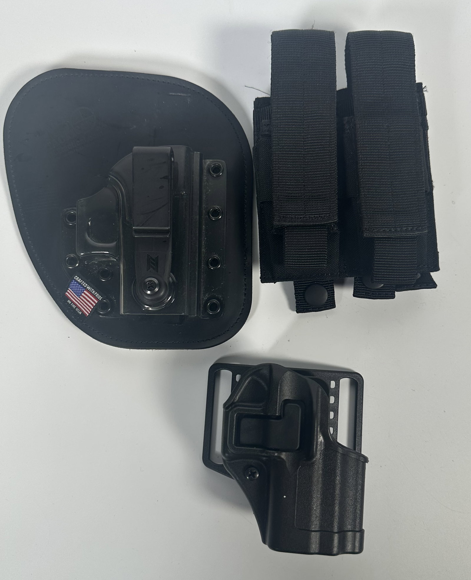 Two Holsters and Belt Clip: Two Holsters and Belt Clip This selection features a hybrid inside-the-waistband (IWB) leather-backed Kydex holster (such as an N8 Tactical or CrossBreed style), a black nylon double magazine pouch,