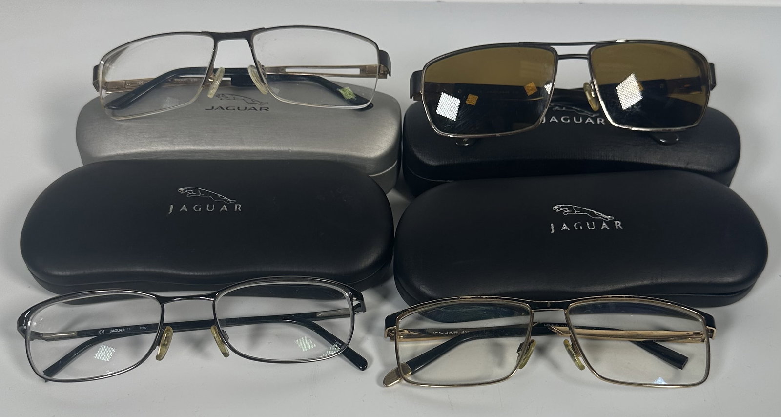 Four Pair Jaguar Sunglasses: Four Pair Jaguar Sunglasses Four pair of sunglasses with cases by Jaguar. Manufactured under license by the German eyewear specialist Ferdinand Menrad GmbH, the brand applies the same attention to