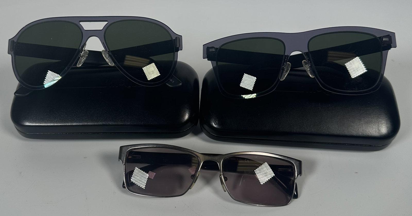 Three Pair Alexander McQueen Sunglasses: Three Pair Alexander McQueen Sunglasses Three pair of sunglasses marked Alexander McQueen. Alexander McQueen sunglasses are manufactured by Kering Eyewear, the specialized luxury eyewear division of