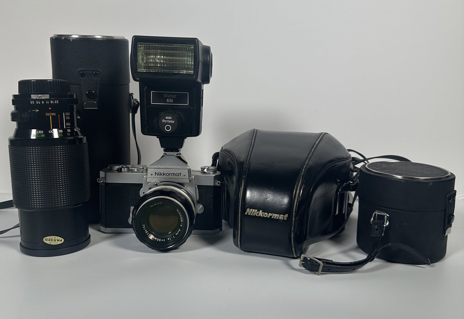 Nikon Niccormat Camera with Vivitar Lenses Incl Zoom: Nikon Niccormat Camera with Vivitar Lenses Incl Zoom A vintage Nikon Nikkormat (also known as Nikomat) 35mm SLR film camera paired with third-party Vivitar lens. Also includes a flash all with cases.