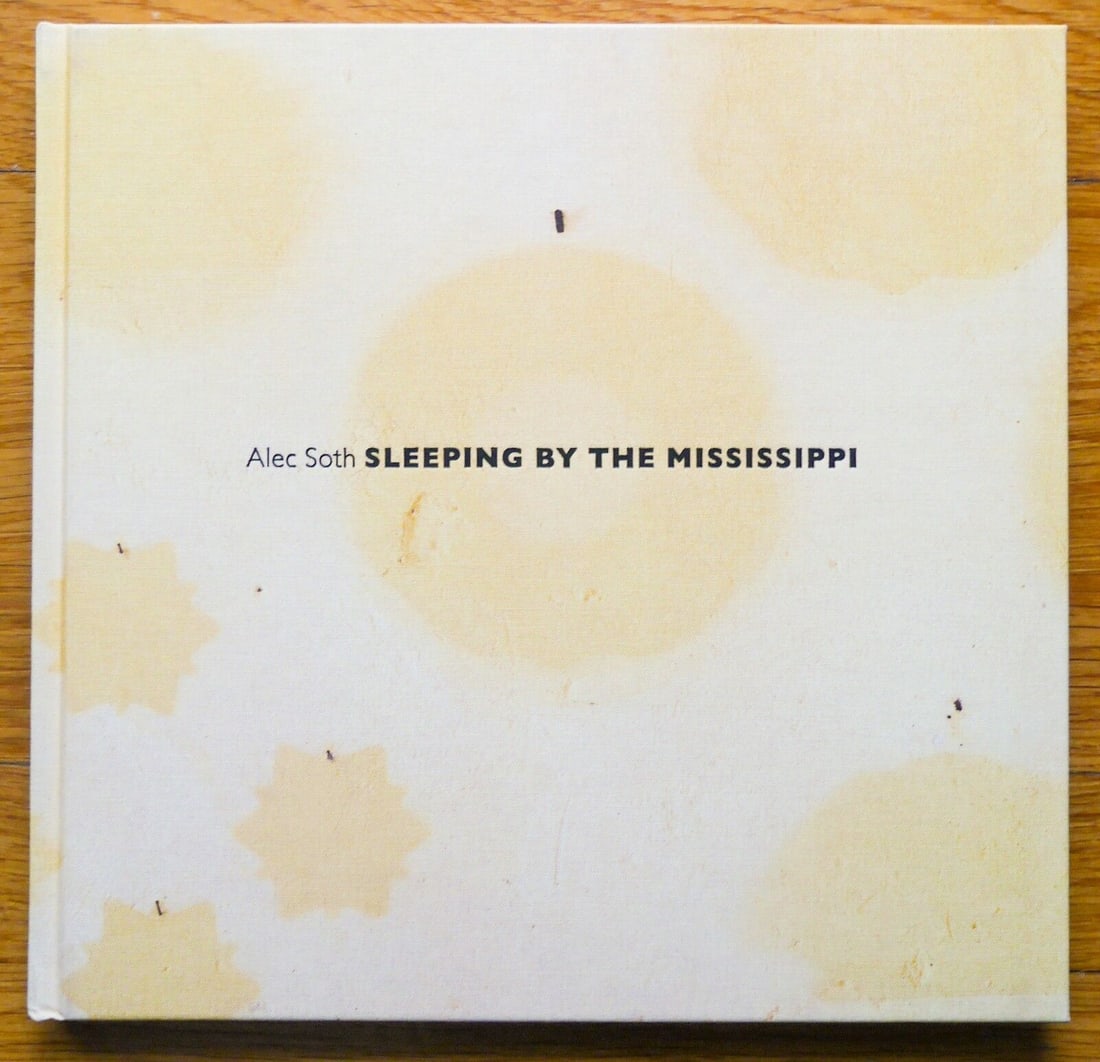 Soth, Alec; Sleeping by the Mississippi [SIGNED - 2017 FOURTH EDITION WITH YELLOW COVER - FINE: Mack, 2017. Hardcover in yellow cloth boards. Fourth Edition. 11 x 11 1/2 inches and has 120 pages with 46 color plates. SIGNED by Alec Soth on the title page. BOOK CONDITION: Fine/As New; a tight, cl