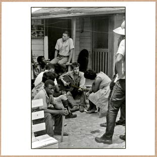 SIGNED - DANNY LYON - BOB DYLAN PLAYING GUITAR BEHIND THE SNCC OFFICE, GREENWOOD, MISSISSIPPI, 1963: Description: 6"x 6" limited edition Fuji Crystal Archival Matte paper print. Image size is 5.5" on the longest side and the paper size is 6" x 6". The Print is SIGNED by Danny Lyon on the verso.Condit