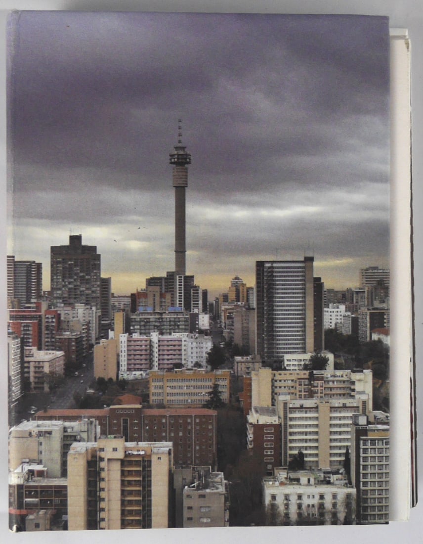 Tillim, Guy; Jo'burg [SIGNED COPY]: SIGNED COPY Filigranes Editions/STE Publishers, 2005. Hardcover in pictorial boards. First Edition, First Printing. Octavo. 126 pages with numerous color photographic images by Guy Tillim. Accordion f