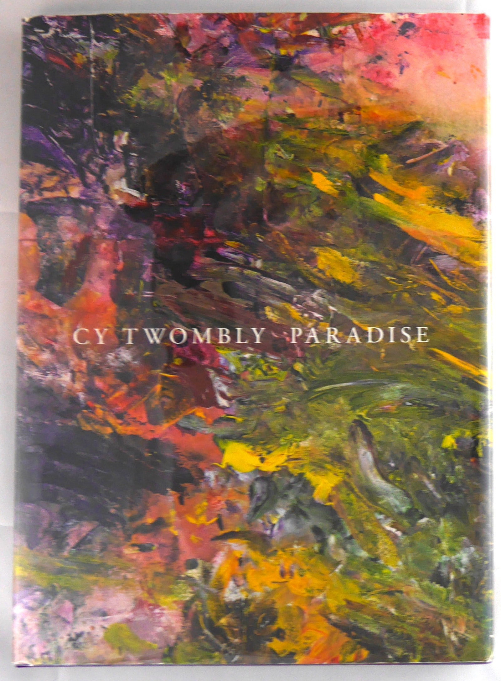 Twombly, Cy; Paradise [2014 DAMIANI 1ST EDITION]: Damiani, 2014. Hardcover in illustrated dust jacket. First Edition, First Printing. 172 pages with 90 illustrations in color, including one four-page gatefold. Text in English. Edited by Julie Sylvest