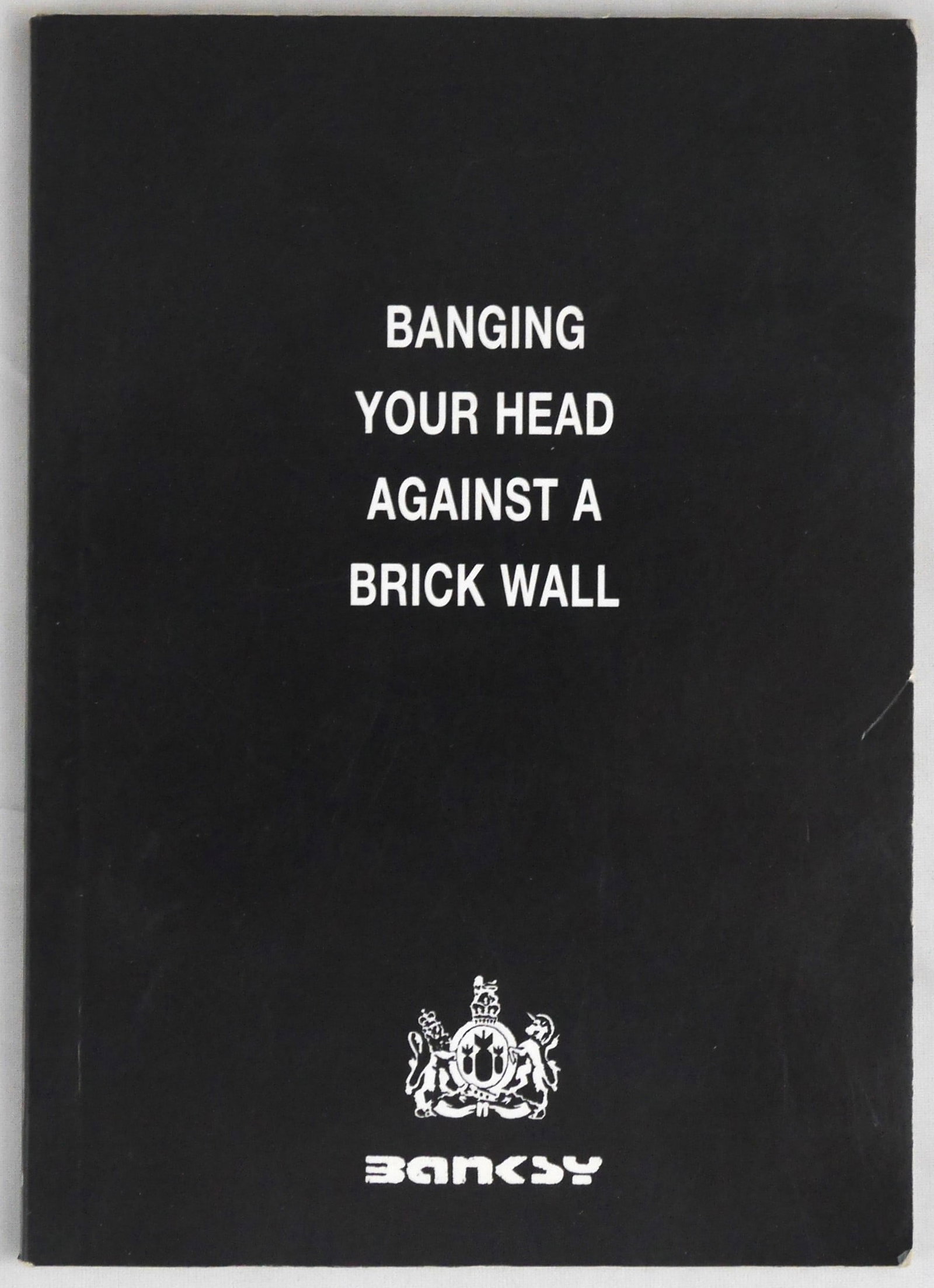Banksy; Bangning Your Head Against a Brick Wall [2001 1ST EDITION & 1ST PRINTING]: Banksy, 2001. Softcover. First Edition, First Printing (only 1000 unnumbered copies): with just the quote and recycling symbol inside the front cover (thus lacking the Banksy email and publicaton info