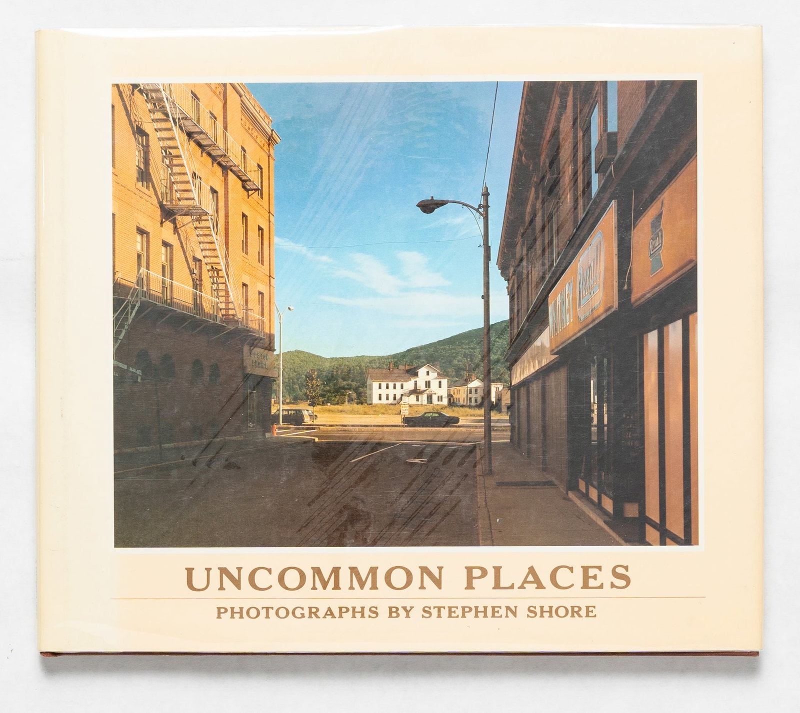 Shore, Stephen; Uncommon Places [1982 1ST EDITION & 1ST PRINTING HARDCOVER WITH DUST JACKET]: Aperture, NY, USA 1982. Hardcover in pictorial dust jacket. First Edition, First Printing. 4to. 63 pages with 49 colour plates. BOOK CONDITION: Fine; a solid, tight, clean copy in a Fine dust jacket w