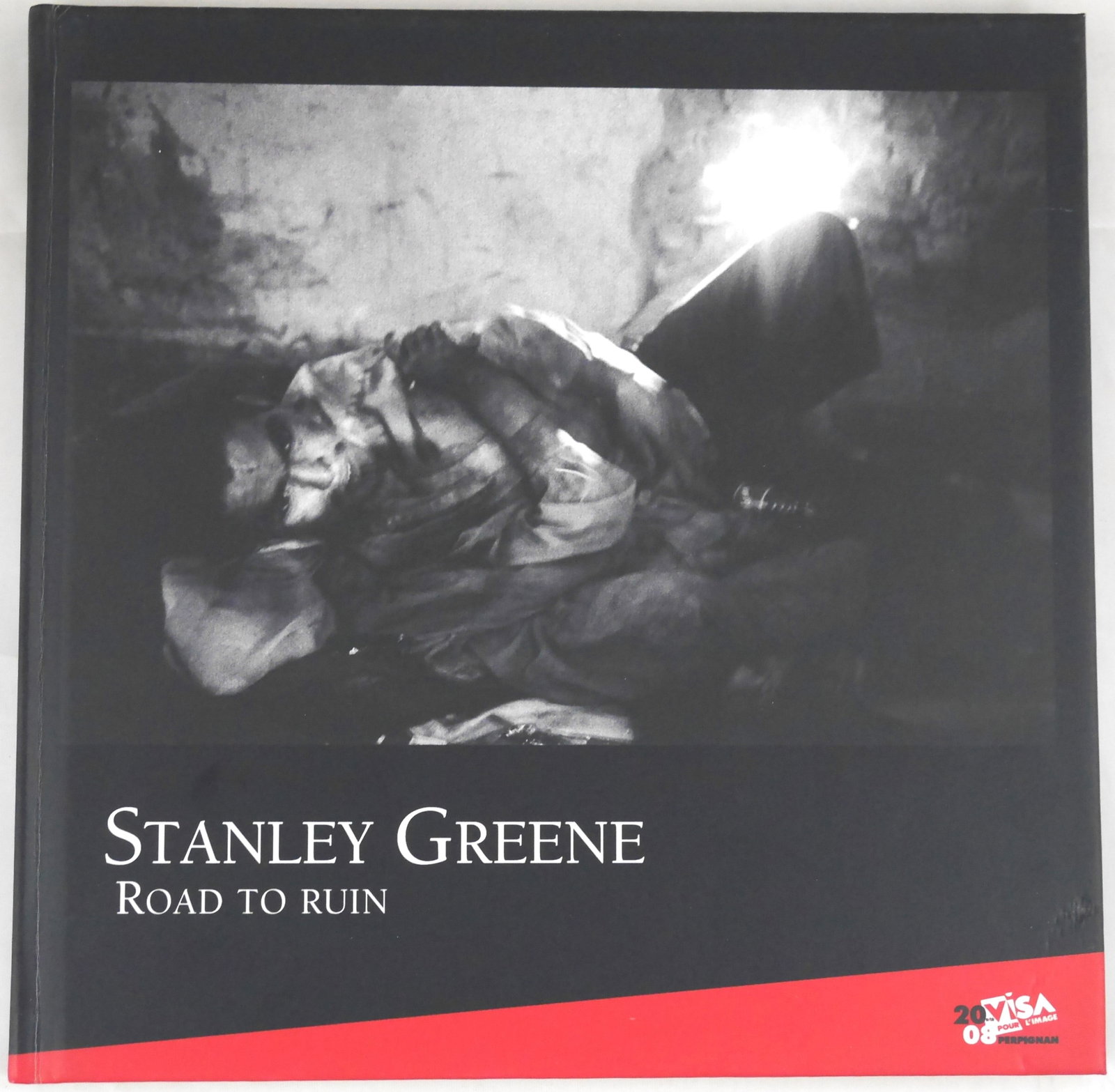 Greene, Stanley; Road to Ruin [RARE LIMITED EDITON #/500 - FINE]: C.D.P. Editions, 2008. Hardcover in pictorial boards. First Edition. Limited Edtion of 500 individually numbererd copies (this being #238/500.Text in french and english. 72 pages with numerous black a