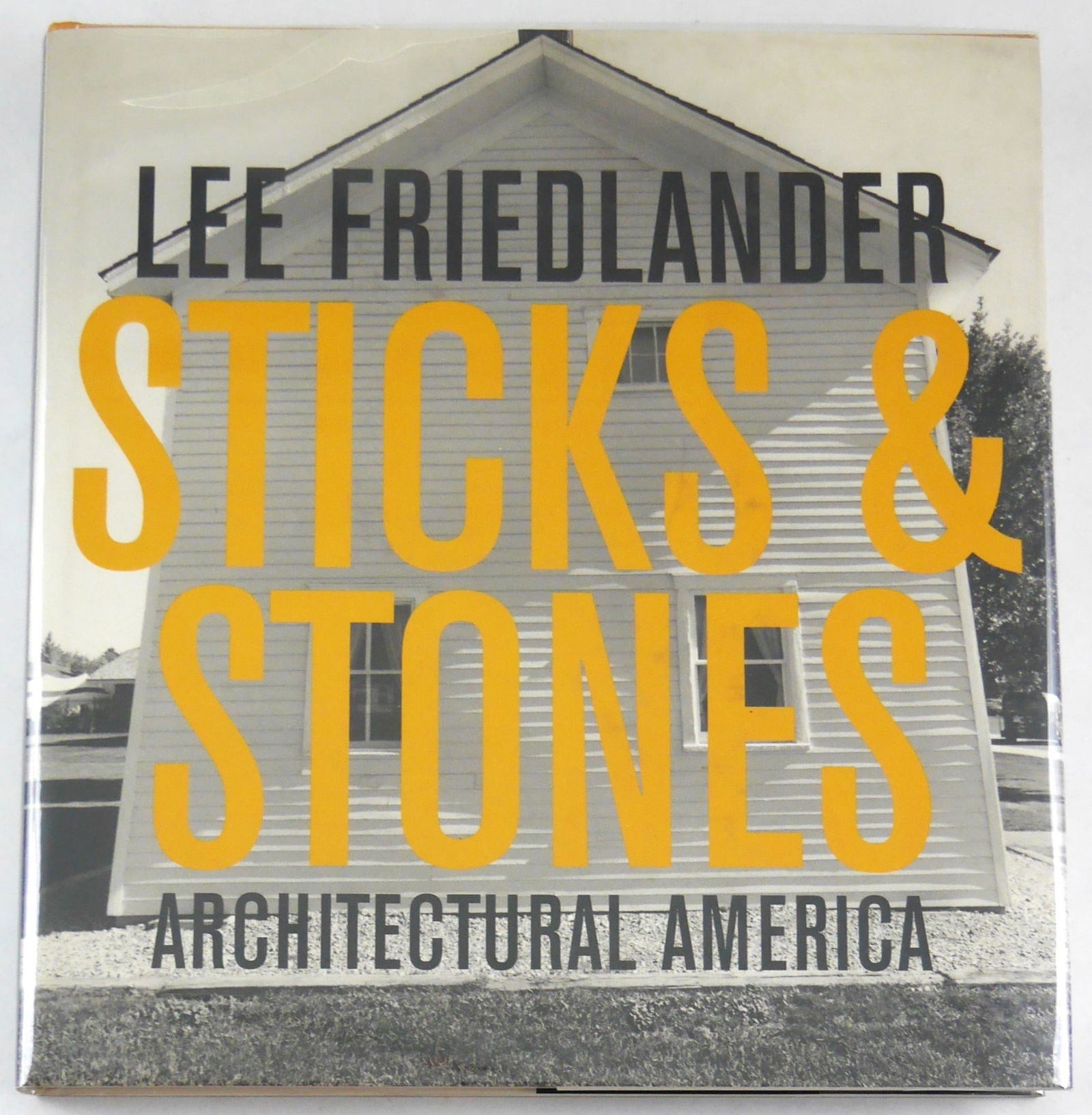 Lee Friedlander (SIGNED): Sticks and Stones Architectural America [2004 1ST ED - FINE]: Fraenkel Gallery, 2004. Hardcover in pictorial dust jacket. First Edition, First Printing. 12 x 12. 216 pages with 192 black and white photographic imges throughout offering Lee Friedlander's view of