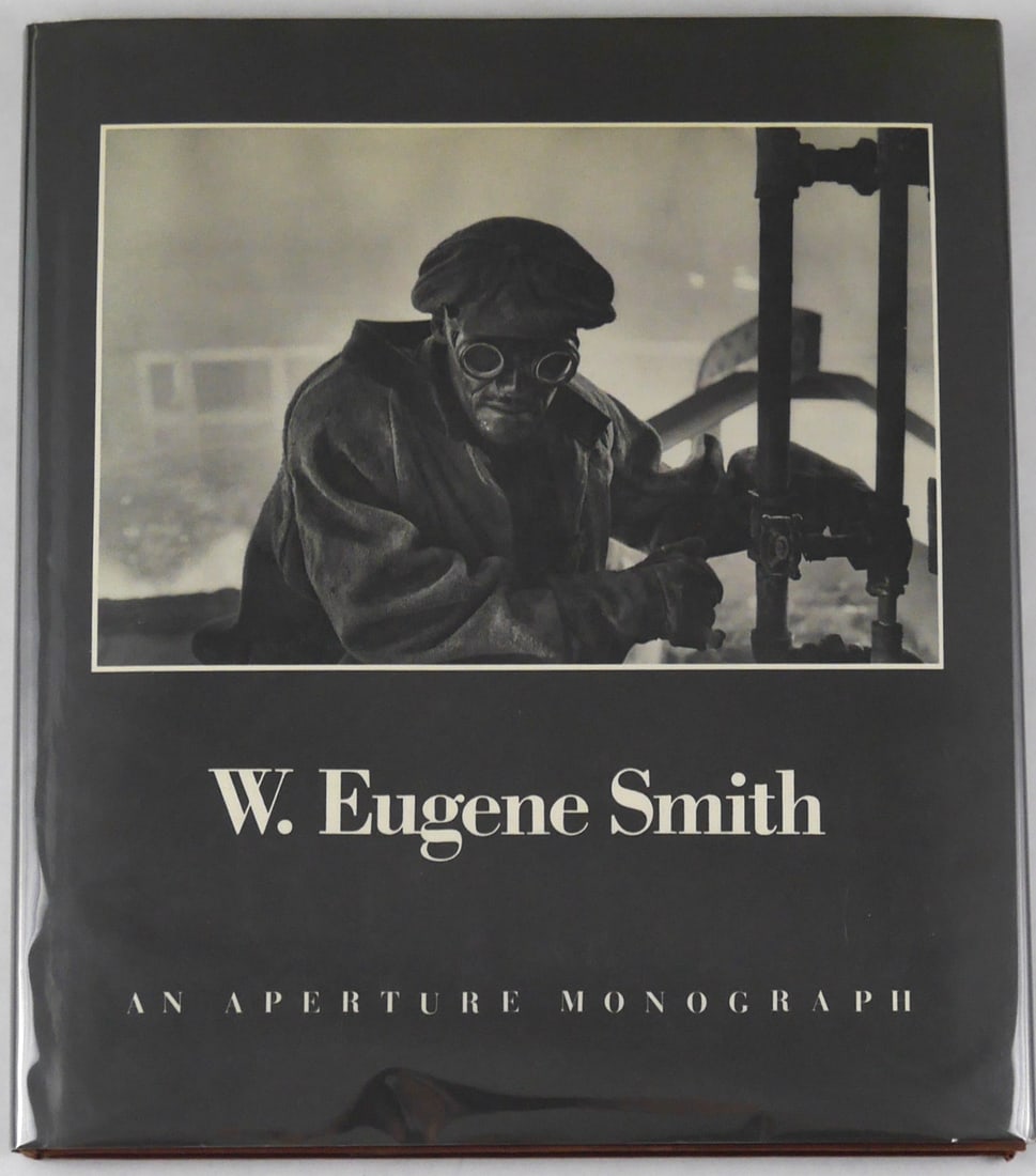 W. Eugene Smith An Aperture Monograph [SIGNED 1969 1ST ED HARDCOVER - FINE]: Aperture, 1969. Hardcover in pictorial dust jacket. First Edition. 10 x 9 inches.Unpaginated with numerous black and white photogrpahic images throughout. Published by Aperture as part of its landmark