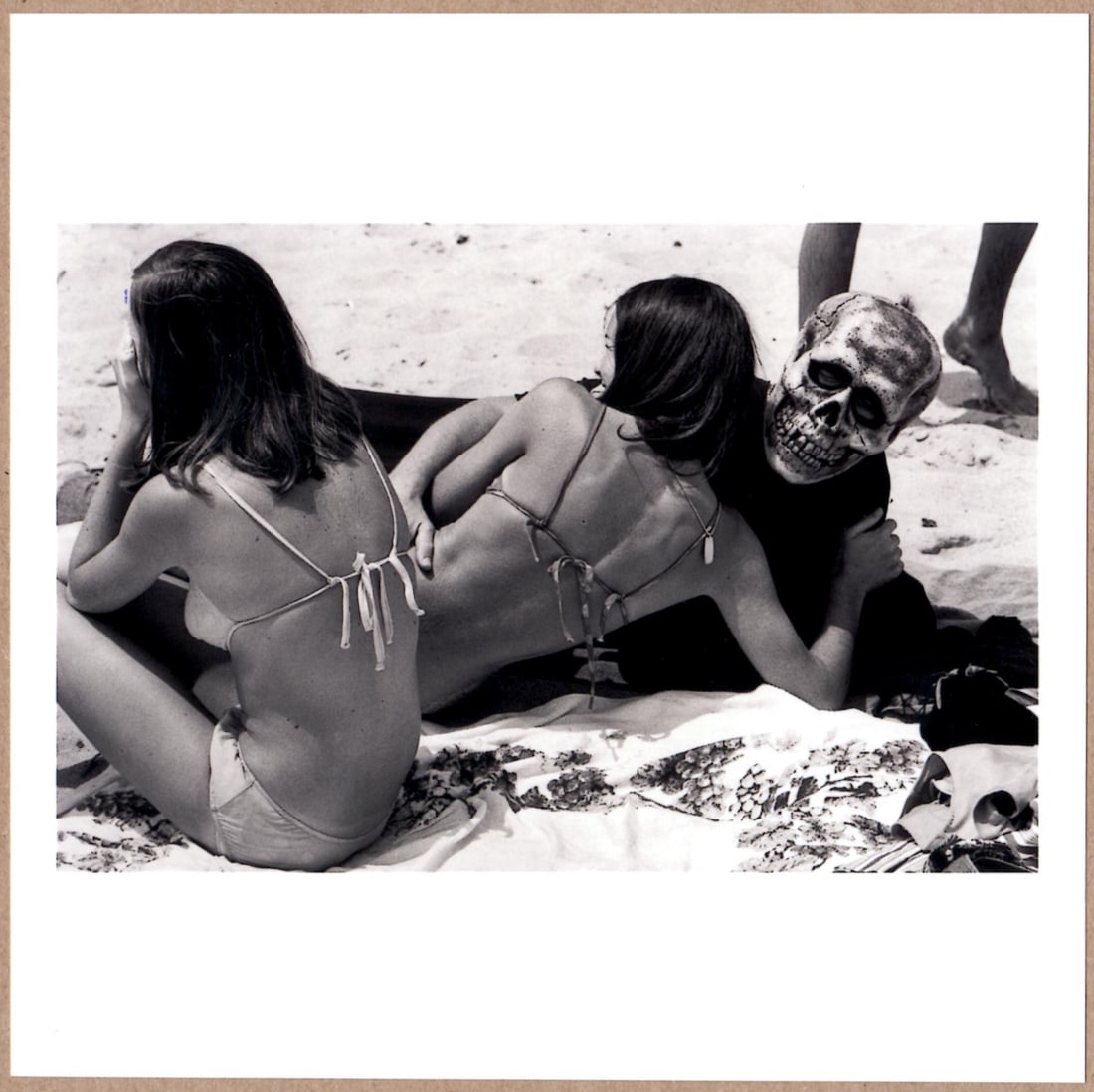 ESTATE STAMPED - DENNIS STOCK - LOVE AND DEATH ON A CALIFORNIA BEACH, 1968 - LTD 6" x 6" PHOTOGRAPH: Description: 6"x 6" limited edition Fuji Crystal Archival Matte paper print. Image size is 5.5" on the longest side and the paper size is 6" x 6". The Print is ESTATE STAMPED on the verso.Condition: B