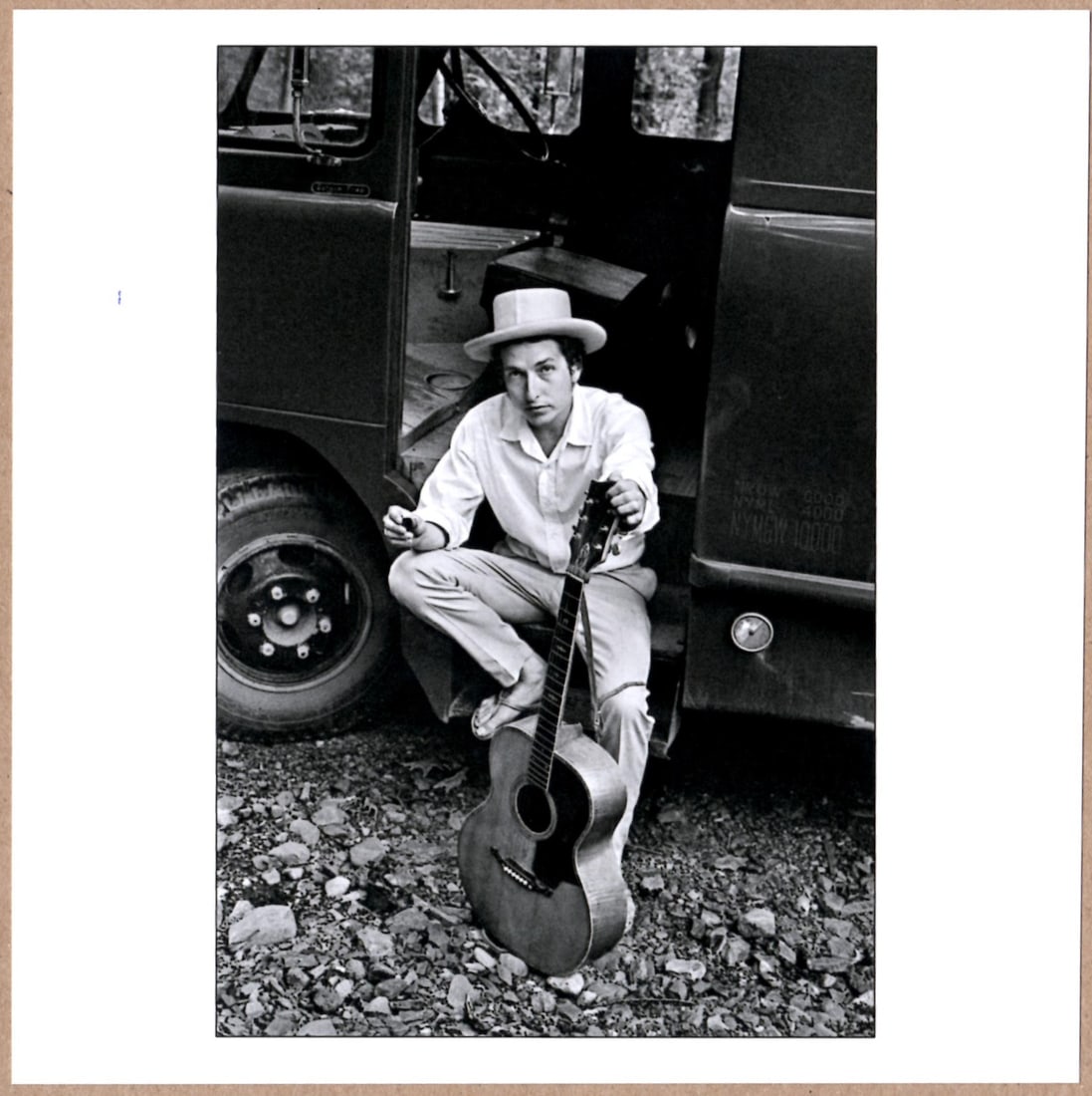 SIGNED - ELLIOTT LANDY - BOB DYLAN ON HIS EQUIPMENT TRUCK, WOODSTOCK, NEW YORK 1968 6" x 6" PHOTO: Description: 6"x 6" limited edition Fuji Crystal Archival Matte paper print. Image size is 5.5" on the longest side and the paper size is 6" x 6". The Print is SIGNED by Elliott Landy on the verso.Con