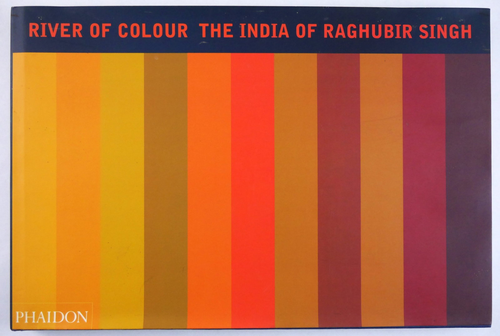 Singh, Raghubir (SIGNED); River of Colour: The India of Raghubir Singh: Phaidon, 1999. Hardcover in pictorial dust jacket. First Edition, First Printing. 11 x 14. 160 pages with numerous color photographic images throughout. SIGNED/INSCRIBED by Singh on the title page 'Fo