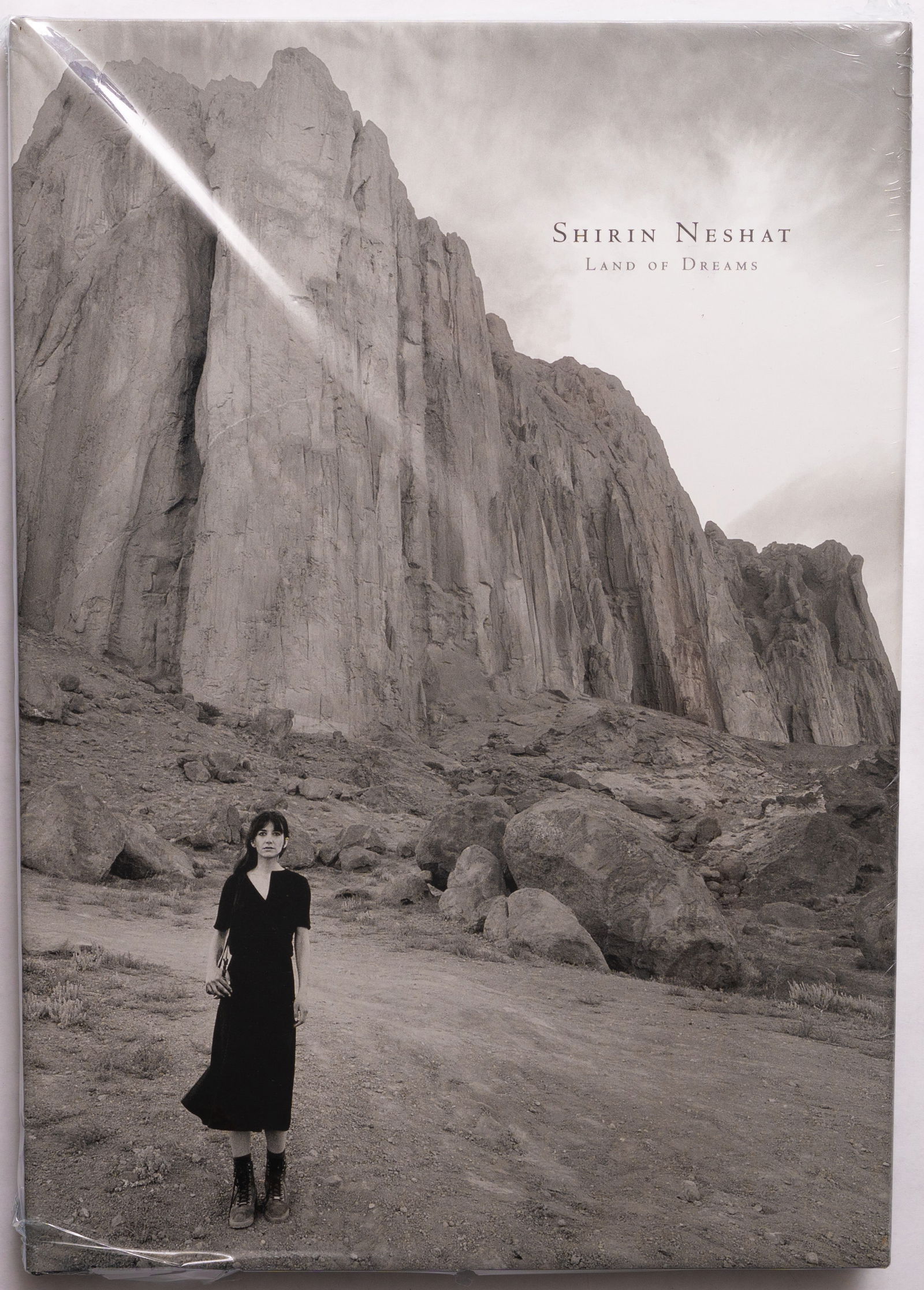 Shirin Neshat, Land of Dreams [SIGNED 2022 1ST EDITION - NEW]: Radius Books, 2022. Hardcover in pictorial dust jacket. First Edition, First Printing. 151 pages with over 100 black and white photographic images throughout .In her latest body of work, multimedia ar