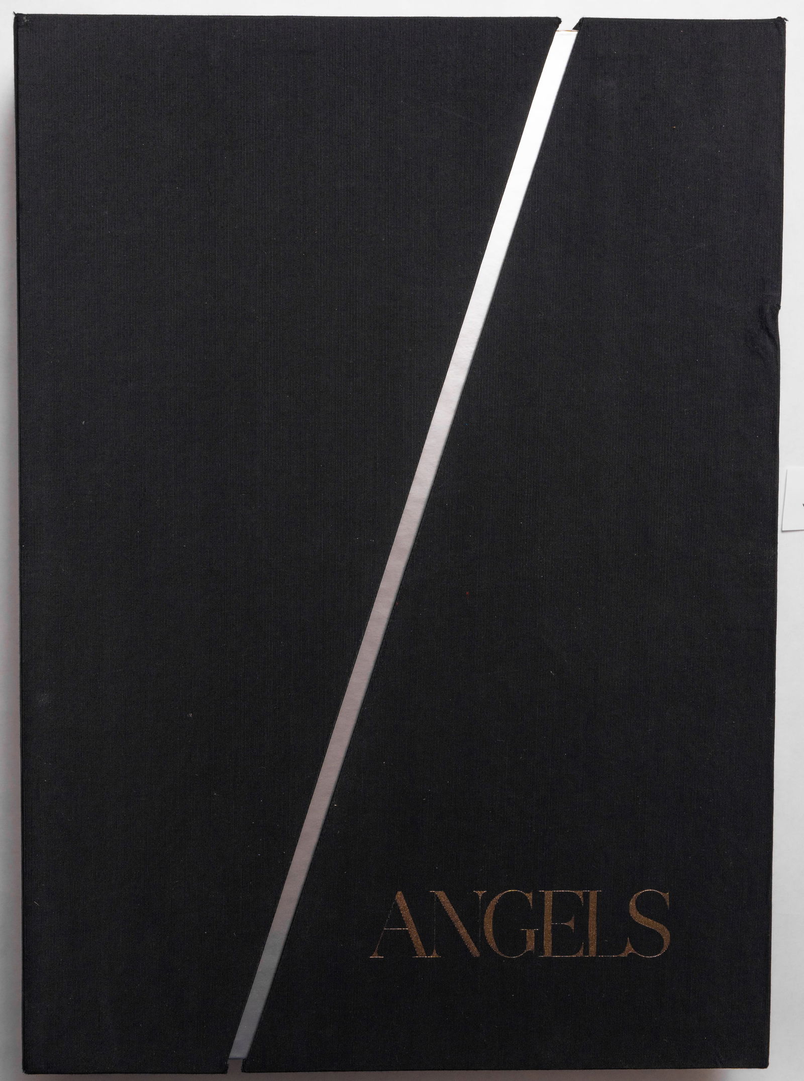 Russell James, Angels / Victoria's Secret Models [SIGNED 2014 LTD IN CLOTH SLIPCASE]: teNues, 2014. Hardcover with tipped in image to front cover housed in a unique 2-piece linen-wrapped slipcase. First Edition, First Printing. Limited Collector's Edition of only 1000 SIGNED and number