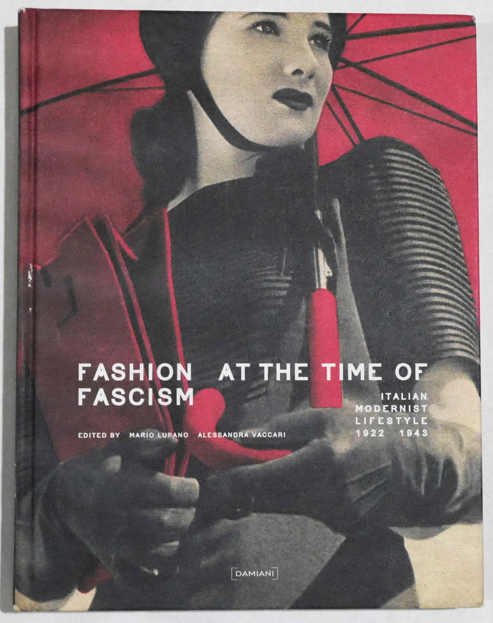 Fashion at the Time of Fascism; Italian Modernist Lifestyle: Damiani, 2009. Hardcover in pictorial boards. First Edition, First Printing. 400 pages with over 1500 photographic images and illustrations throughout. Authors Mario Lupano and Alessandra Vaccari expl