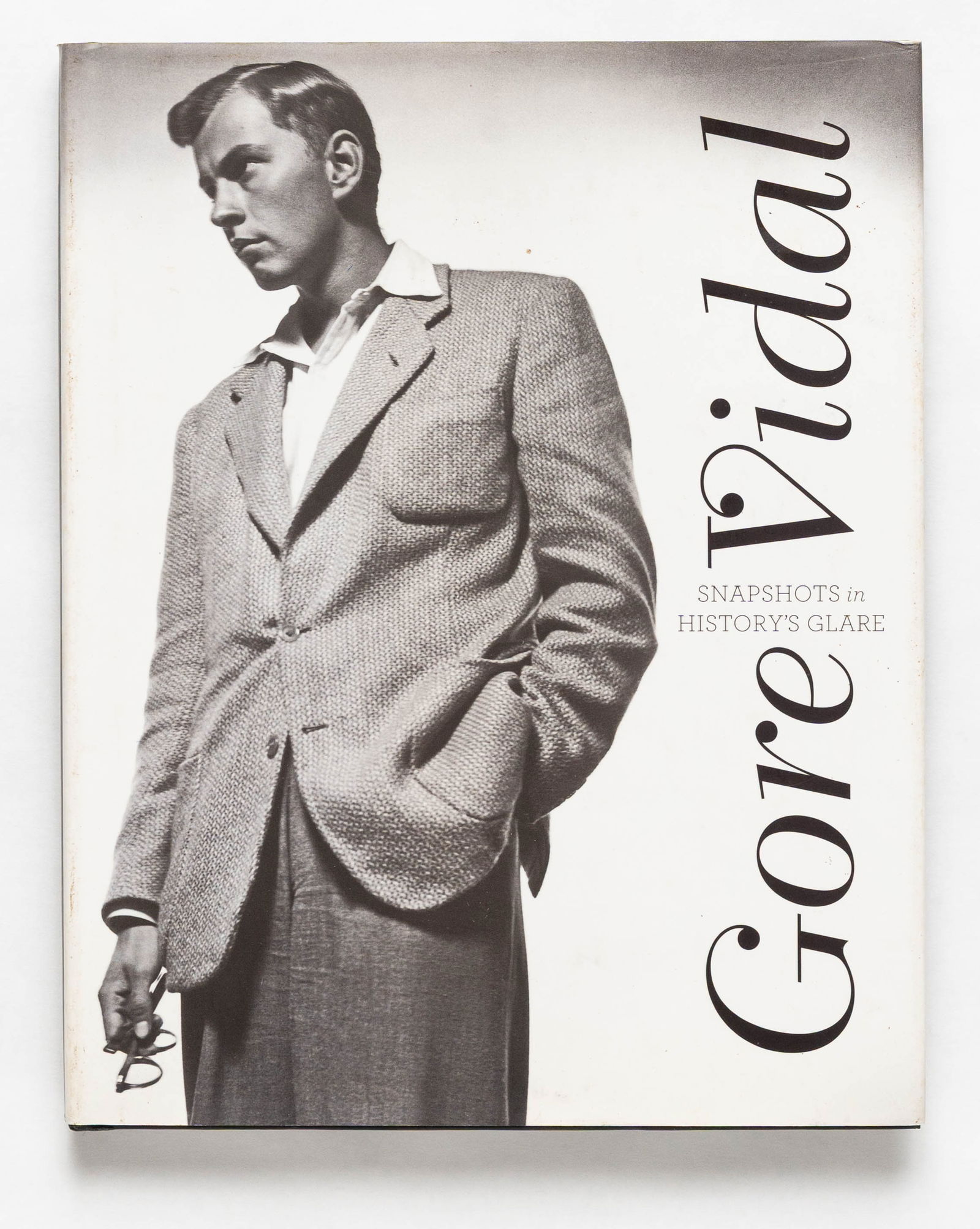 Gore Vidal, Snapshots in History's Glare [SIGNED by Gore Vidal - 2009 1ST EDITION - FINE]: SIGNED COPY - Harry Abrams, 2009. Hardcover in pictorial dust jacket. First Edition, First Printing (with the full numberline ending in 1). 255 pages with numerous photographic images throughout. "Thi