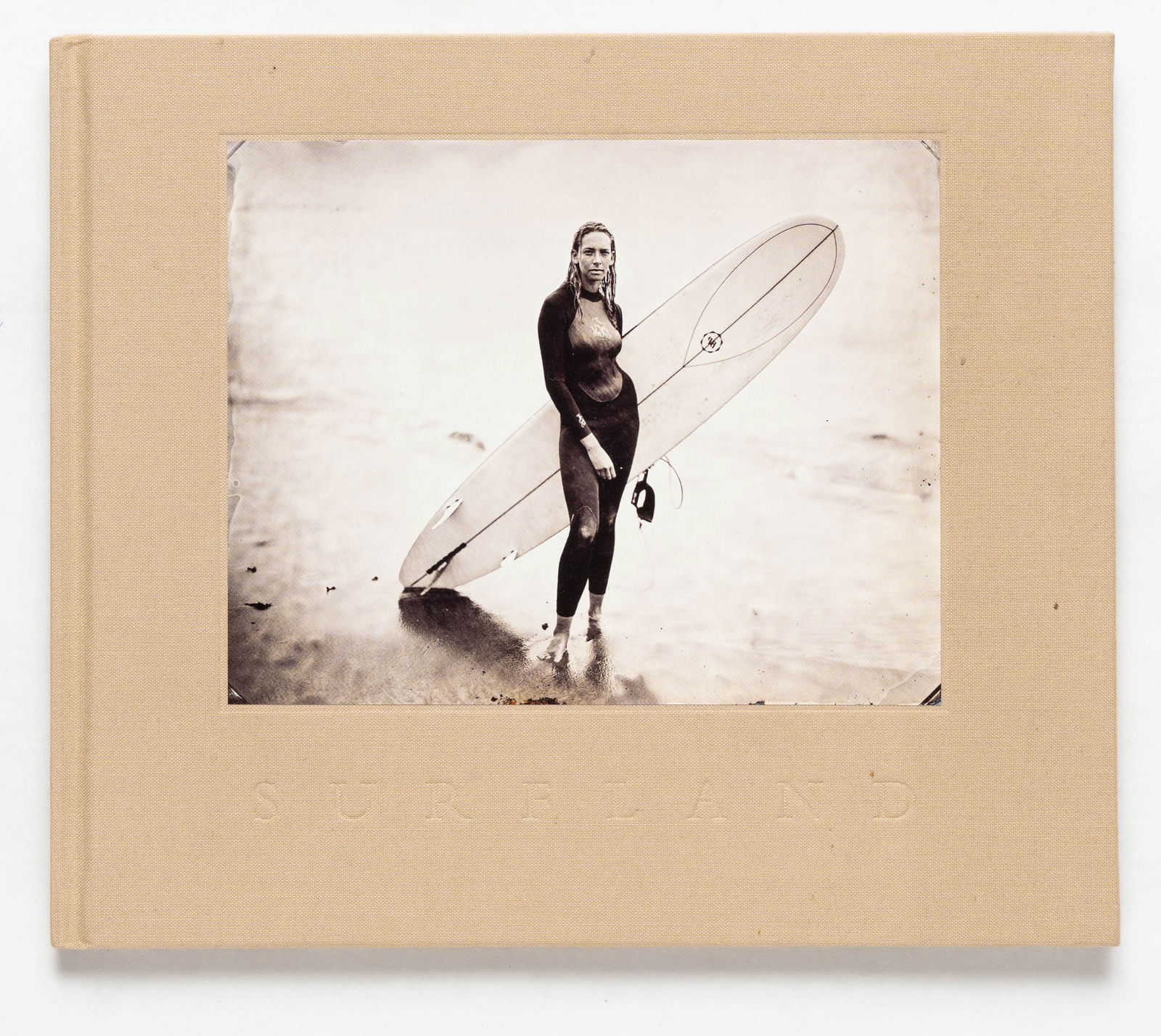 Sternbach, Joni; Surfland [RARE 2007 1ST EDITION HARDCOVER]: Photolucida, 2007. Hardcover with tipped-in photograph on the cover. 8vo, A series of black and white portraits of surfers from Montauk to Carpenteria, Ca., evoking a sense of history, rawness, and na