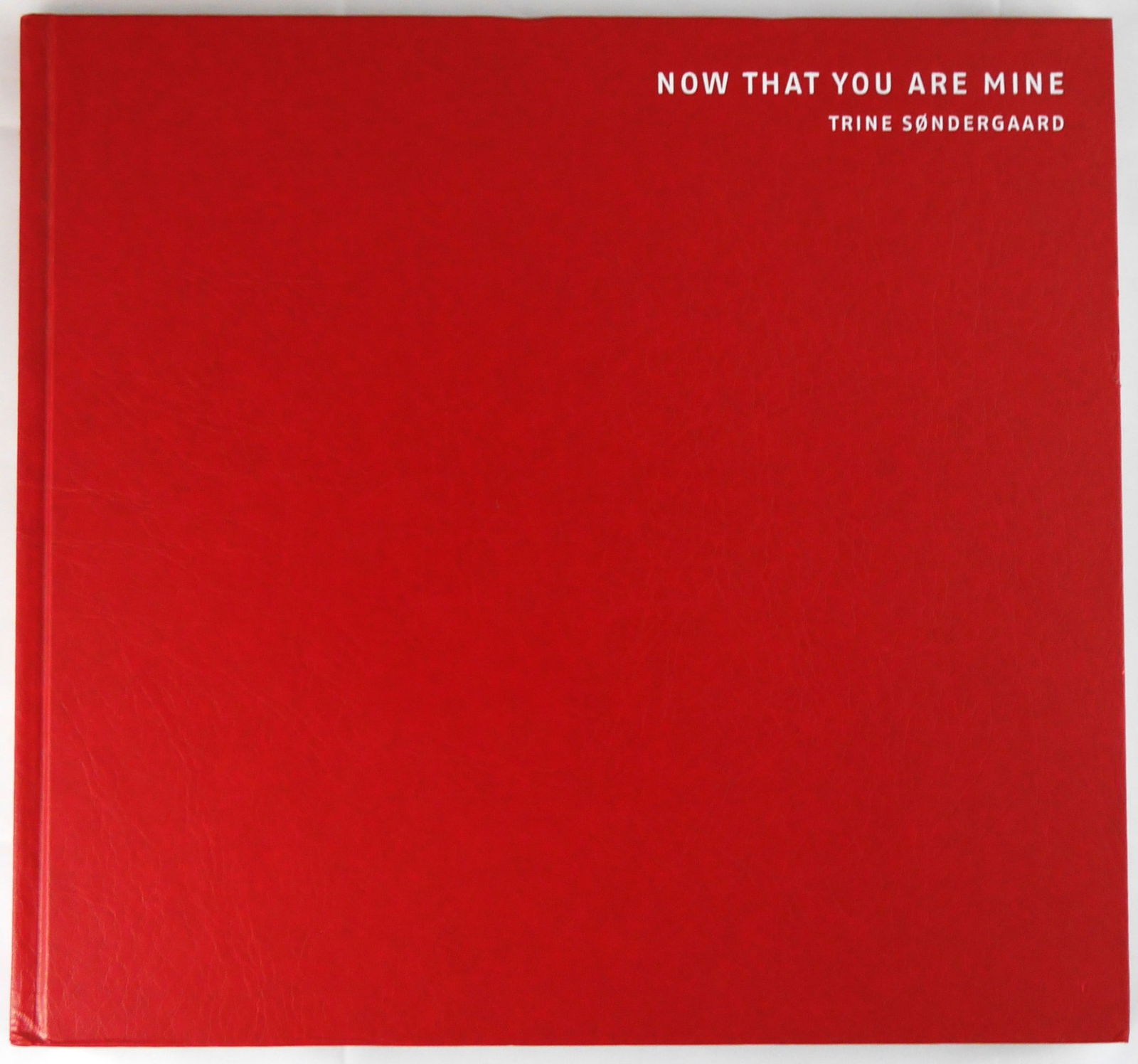 Sondergaard,Trine; Now That You Are Mine [2003 1ST EDITION & 1ST PRINTING - FINE COPY]: Steidl, 2002. Hardcover in red leatherette boards with title in white to front panel and spine. 72 pages with numerous photographs taken by Sondergaard in the Skelbaekgade area of Copenhagen Denmark f