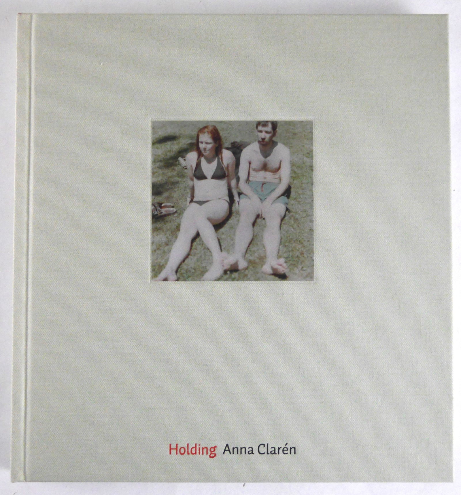 Claren, Anna; Holding [2006 1ST EDITION - FINE]: Journal, Stockholm. 2006. Hardcover. First edition, first printing. Hardback with full grey cloth and tipped-in-photograph. 9 1/4 x 10 5/8 inch. 128 pages with 63 color photographs by Anna Claren. Lay