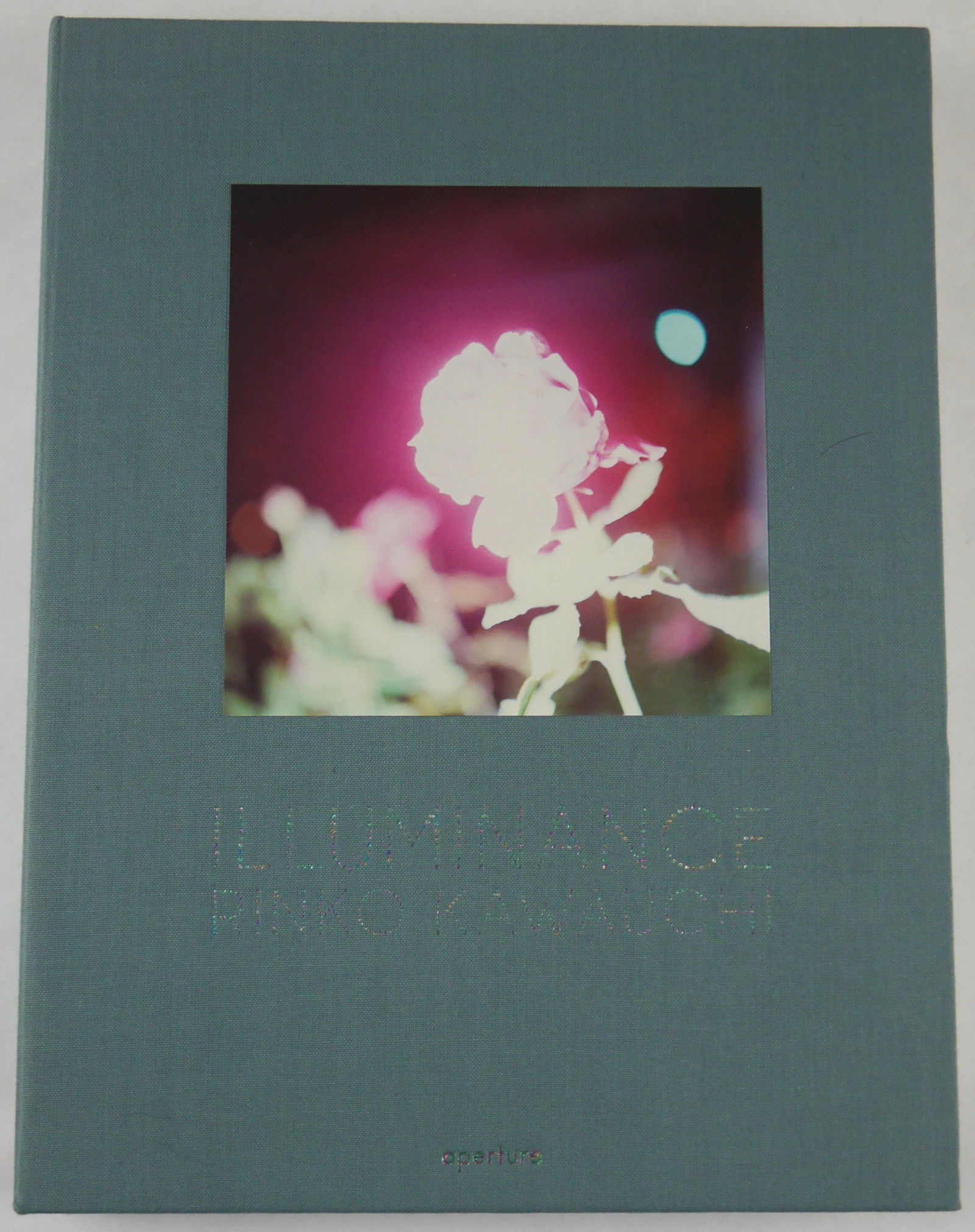 Kawauchi, Rinko; Illuminance [SIGNED - 2011 APERTURE 1ST EDITION & 1ST PRINTING - FINE]: Aperture, 2011. Hardcover with tipped-on image to front cover. First Edition, First Printing )with full numberline ending in 1). 176 pages with 130 color photographic images throughout featuring a bea