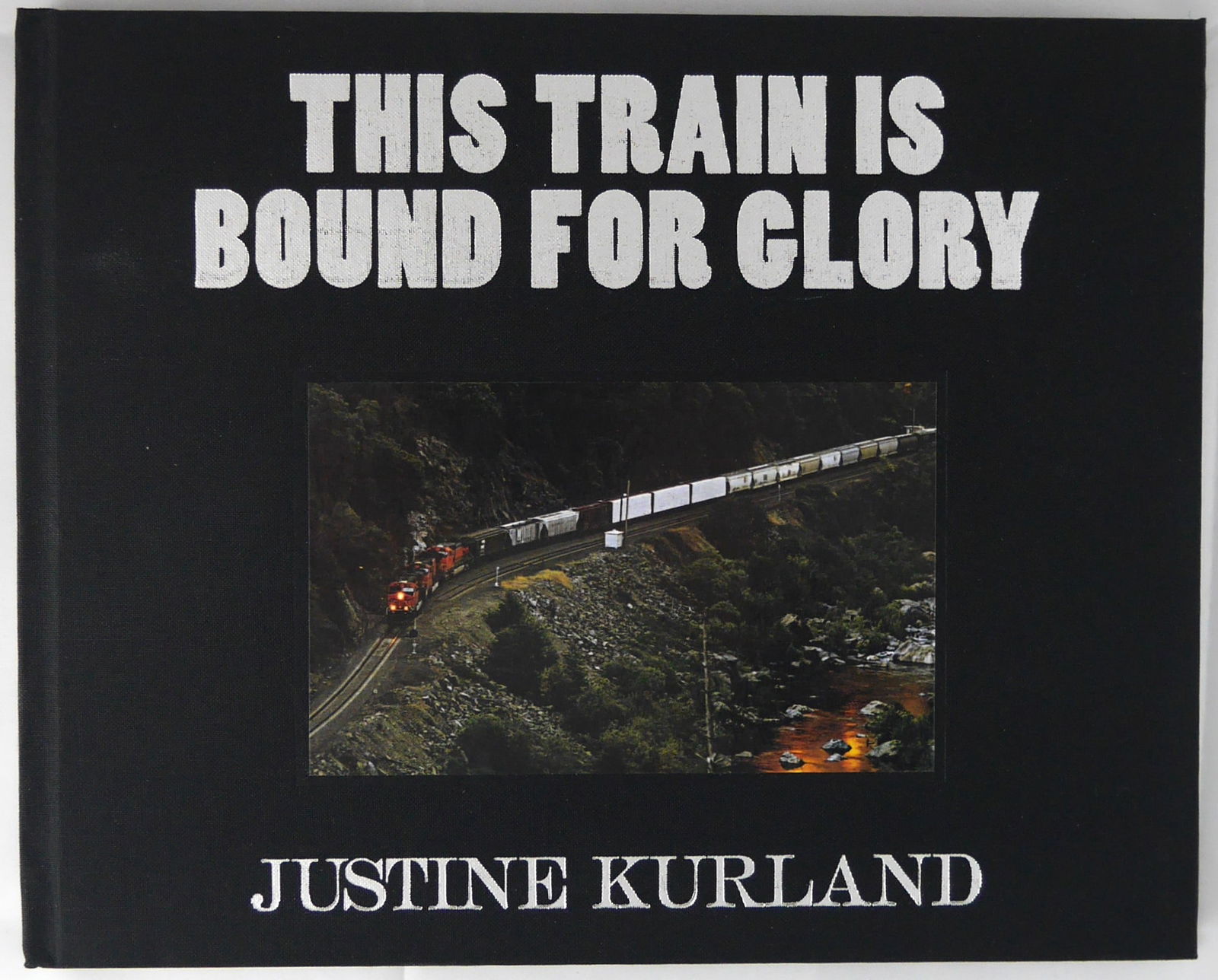 Kurland, Justine; This Train is Bound for Glory [SIGNED & NUMBERED 1ST EDITION HARDCOVER - FINE: Ecstatic Peace Library and D.A.P, 2009. Hardcover - the rare variant in black cloth boards with title/author's name blind stamped in silver to front cover and spine, and a tipped in photographic image