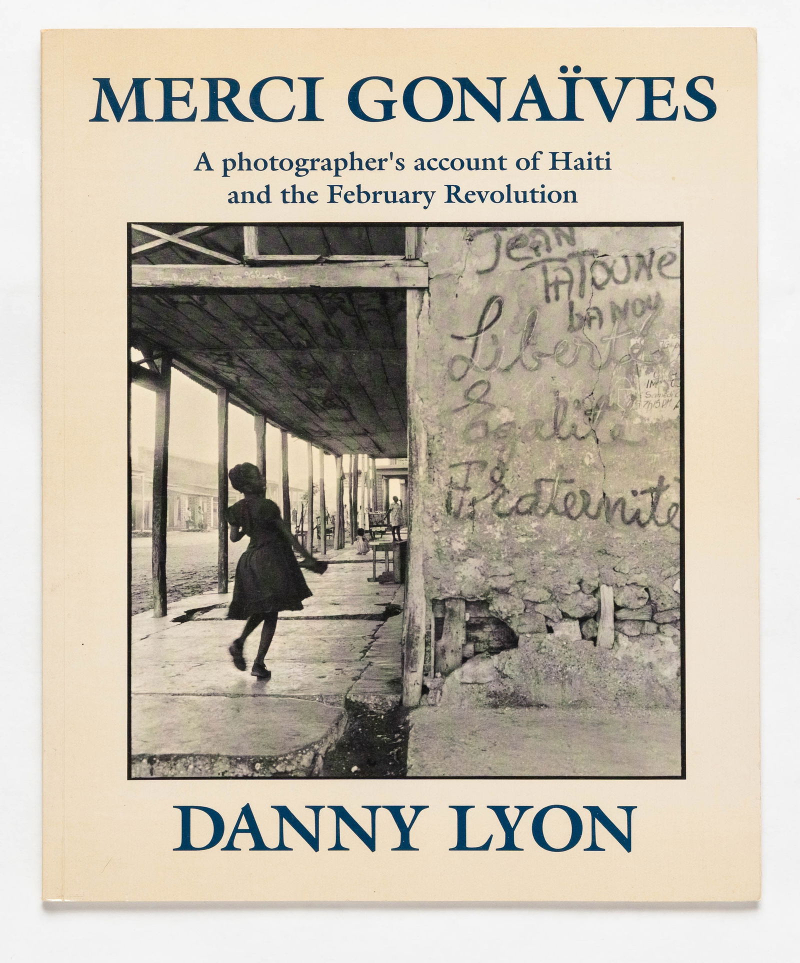 Danny Lyon, Merci Gonaives [SIGNED 1988 1ST EDITION - FINE]: Bleak Beauty Books, 1988. Softcover in pictorial wrappers. First Edition, First Printing. 61 pages with numerous black and white photographic images throughout Danny Lyon's account of the fall of the
