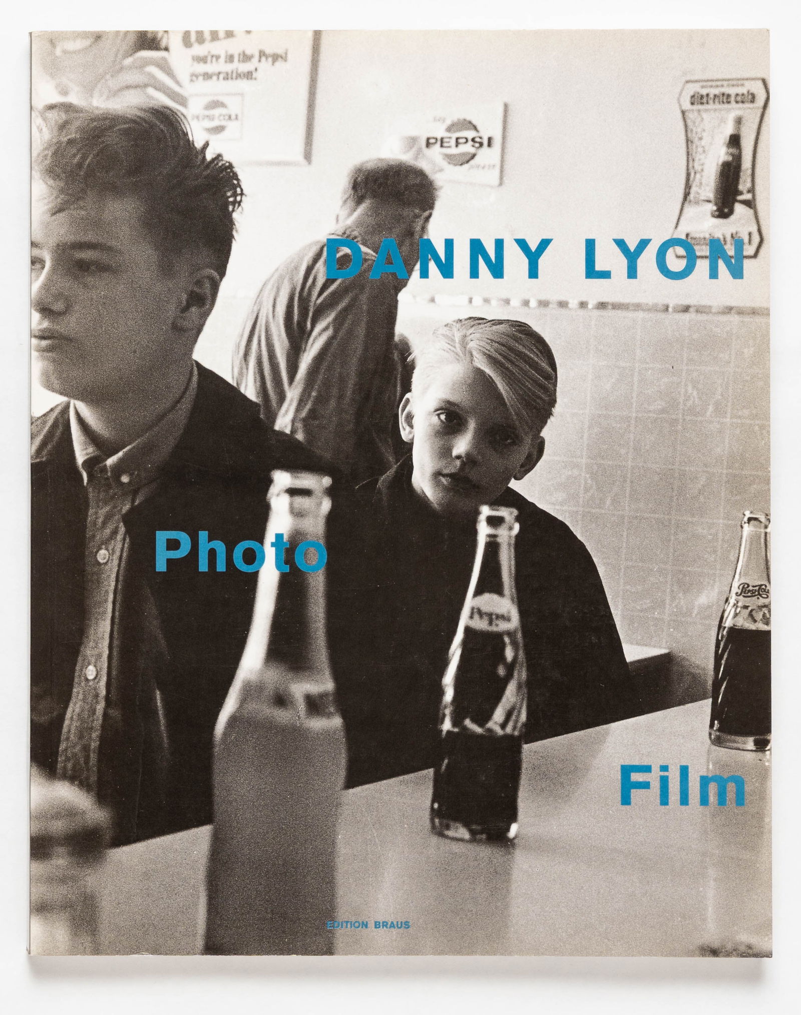 Danny Lyon, Photo Film [SIGNED 1991 1ST EDITION 1ST PRINTING - FINE]: Edition Braus, 1991. Softcover in pictorial wrappers. First Edition, First Printing. 12 x 9 inches. 188 pages illustrated with high quality duotones throughout, including many previously unpublished i