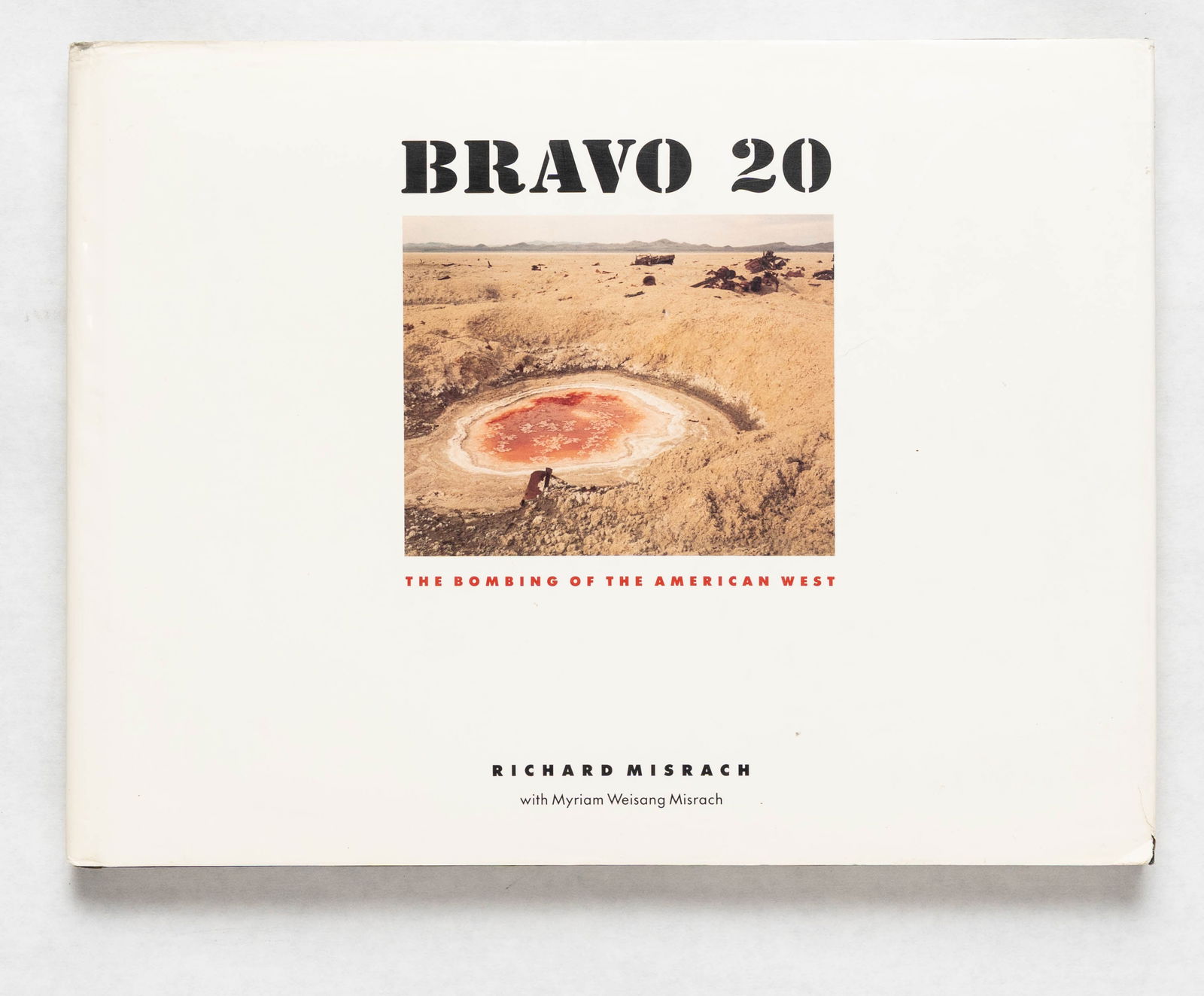 Misrach, Richard; Bravo 20: The Bombing of the American West [SIGNED 1ST EDITION HARDCOVER]: The Johns Hopkins University Press, 1990. Hardcover in pictorial dust jacket. First edition, First Printing. 12 x 9 inches. 234 pages with numerous color photographic imag by Richard Misrach. Accompan