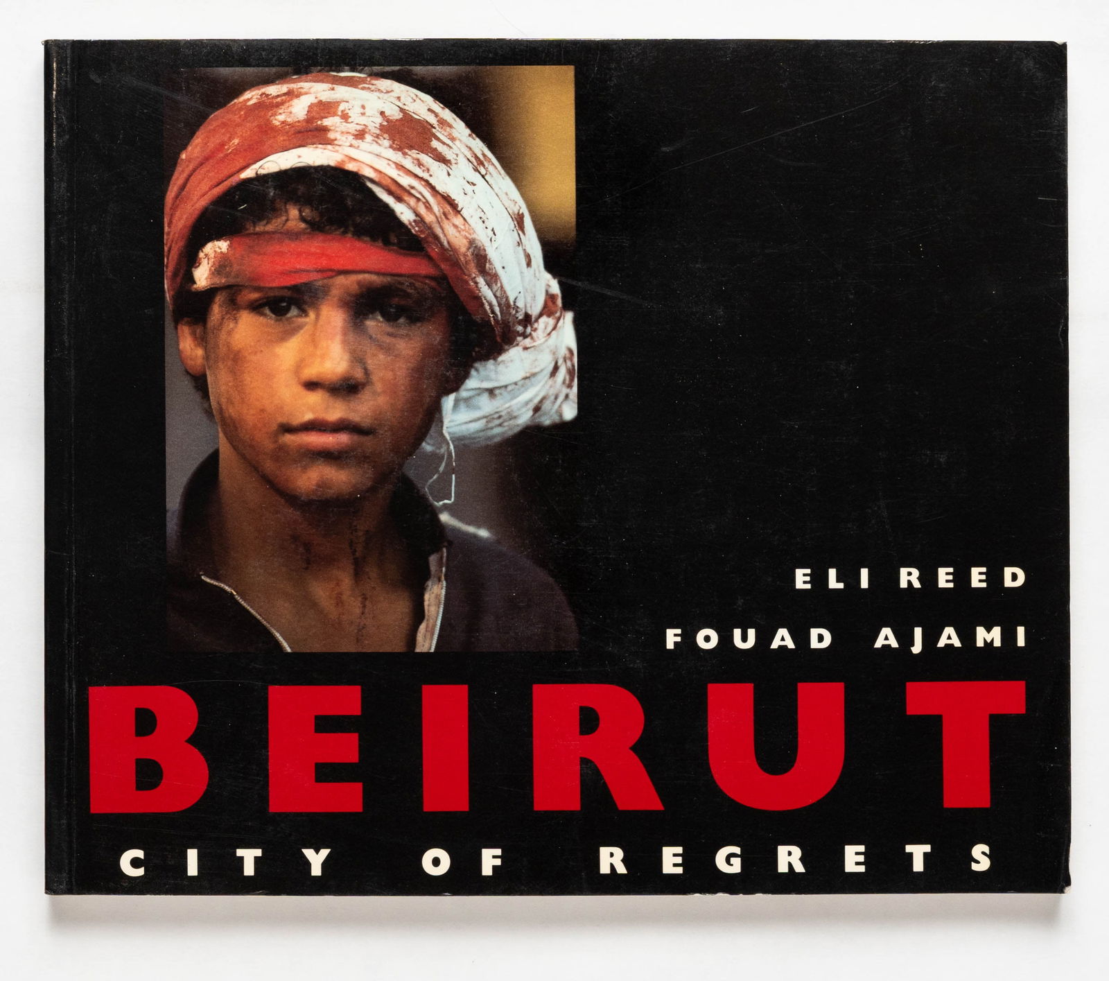 Reed, Eli; Ajami, Fouad; Beirut City of Regrets [1988 1ST EDITION 1ST PRINTING]: Norton, 1988, Siftcover in pictorial wrappers. First Edition (stated), First Printing (with full numberline ending in 1). 4 x 5.5 inches. 188 pages with numerous color photographic images throughout b