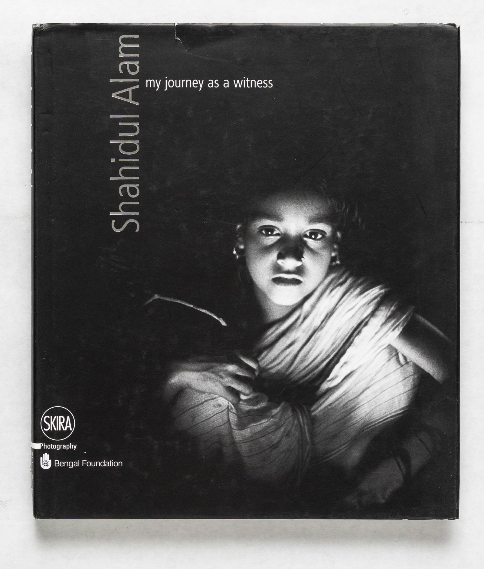 Sebastião Salgado; Raghu Rai; Shahidul Alam: My Journey as a Witness [2011 1ST EDITION - FINE]: Skira / Bengal Foundation, 2011. Hardcover in pictorial dust jacket. First Edition, First Printing. 222 pages with numerous black and white and color photographic images throughout by an extraordinary