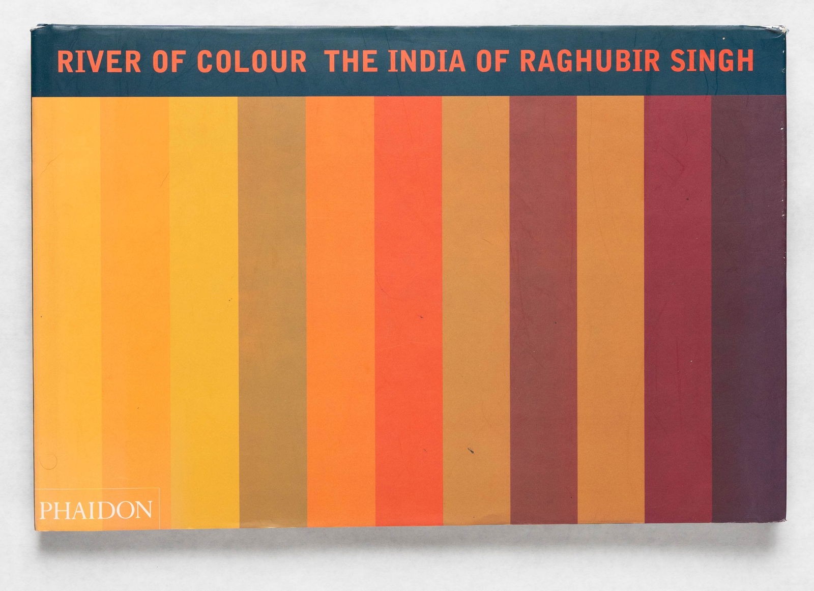 Singh, Raghubir; River of Colour, The India of Raghubir Singh [1998 1ST EDITION - FINE]: Phaidon, 1998. Hardcover in pictorial dust jacket. First Edition (stated), First Printing. 11 x 14. 160 pages with numerous color photographic images throughout. Since the 1960s Singh has roamed far a
