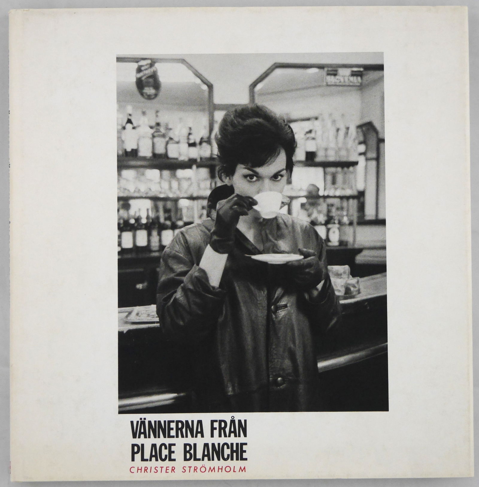 Stromholm, Christer; Vannerna Fran Place Blanche [1983 1ST EDITION - FINE COPY]: Stockholm. AB Tiprod (ETC:s förlag), 1983. Hardcover in white cloth lettered in black in pictorial dustjacket featuring Nana drinking coffee. 9¼ x 9¼ inches. 110 pages with 80