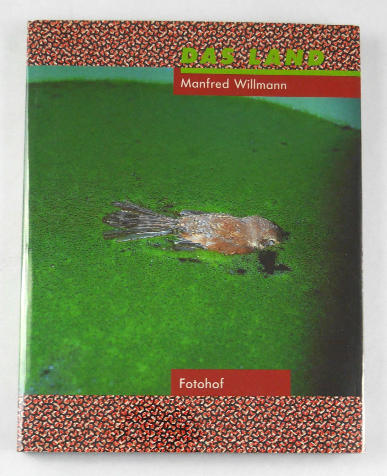 Willmann, Manfred; Das Land 1981-1993 [2000 1ST EDITION & 1ST PRINTING - FINE COPY]: Fotohof, Salzburg, 2000. Hardcover in pictorial dust jacket (lacking the playing card). First edition, first printing. 270 x 210 mm (10 1/2 x 8 1/4 in). 144 pages with 125 color photographic images th