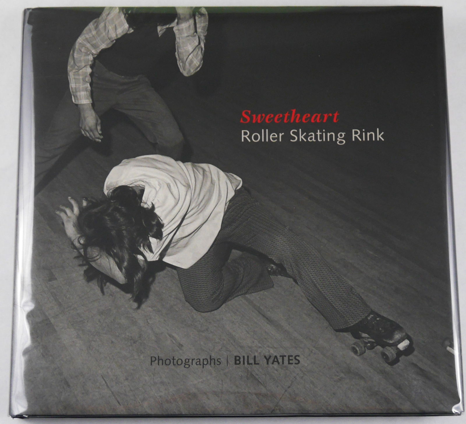 Yates, Bill; Sweetheart Roller Skating Rink [2016 1ST EDITION 1ST PRINTING - FINE]: Fall Line Press, 2016. Hardcover in pictorial dust jacket. First edition and first printing. Oblong hardcover. 132 pages with 76 black and white photographic images of roller skaters in their local ro