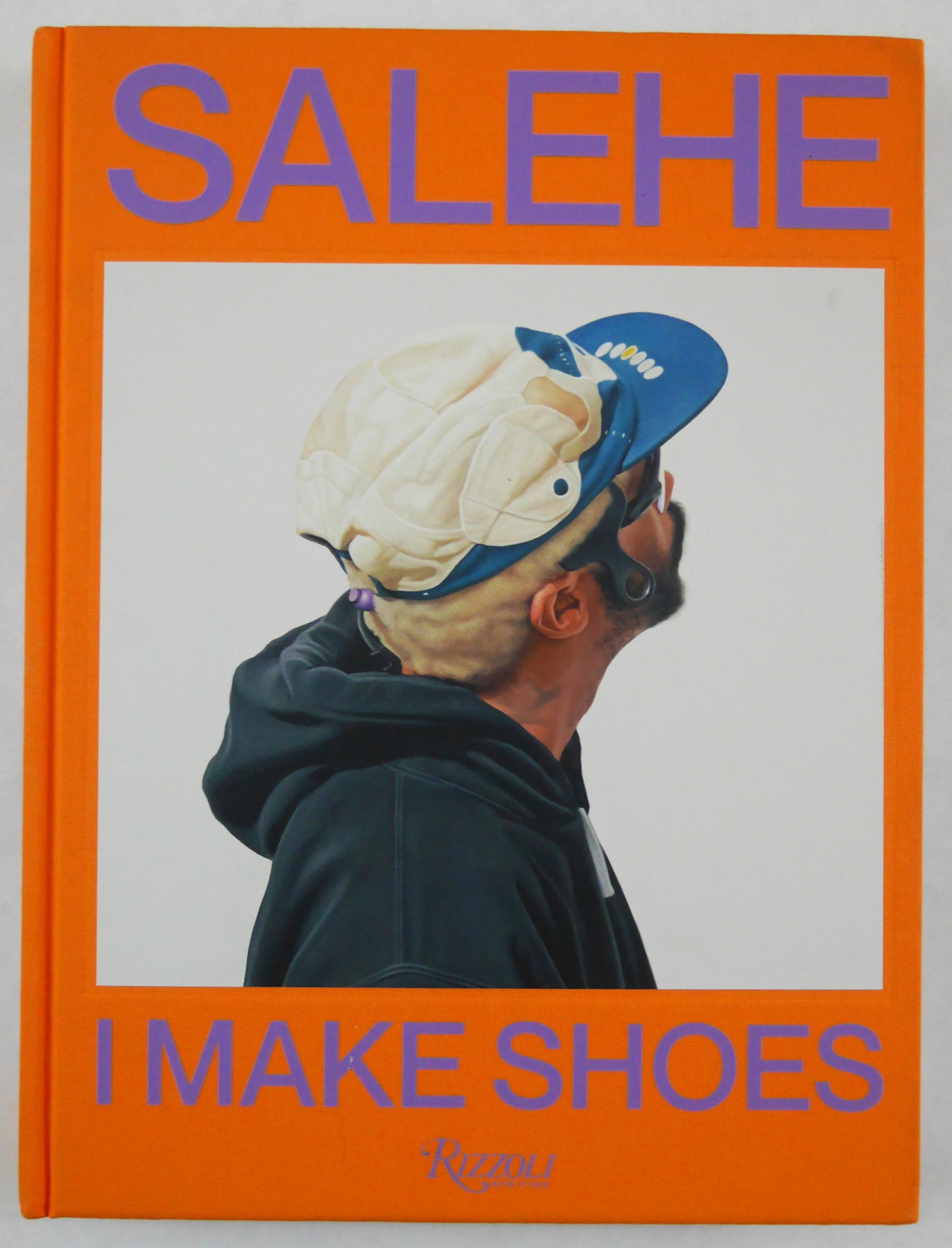 Bembury Salehe, I Make Shoes [SIGNED - 2025 1ST EDITION, FIRST PRINTING - FINE]: SIGNED COPY - Rizzoli, 2025. Hardcover in orange cloth boards with tipped in image to front cover. First Edition, First Printing.? 14 x 12 inches. 375 pages with numerous photographic images and illus